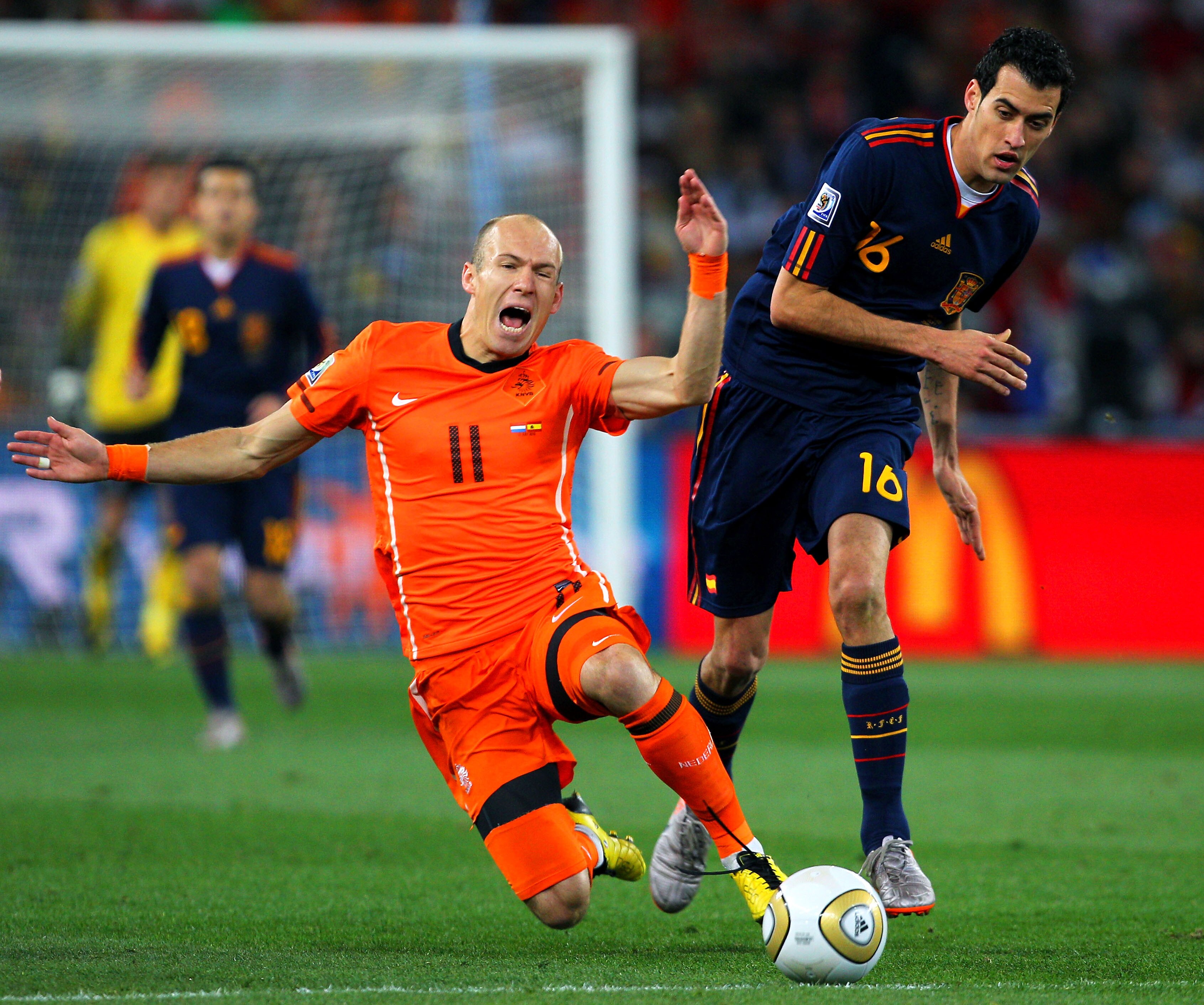 JOHANNESBURG, SOUTH AFRICA - JULY 11:  Arjen Robben of the Netherlands falls to the ground after being tackled by Sergio Busquets of Spain during the 2010 FIFA World Cup South Africa Final match between Netherlands and Spain at Soccer City Stadium on July