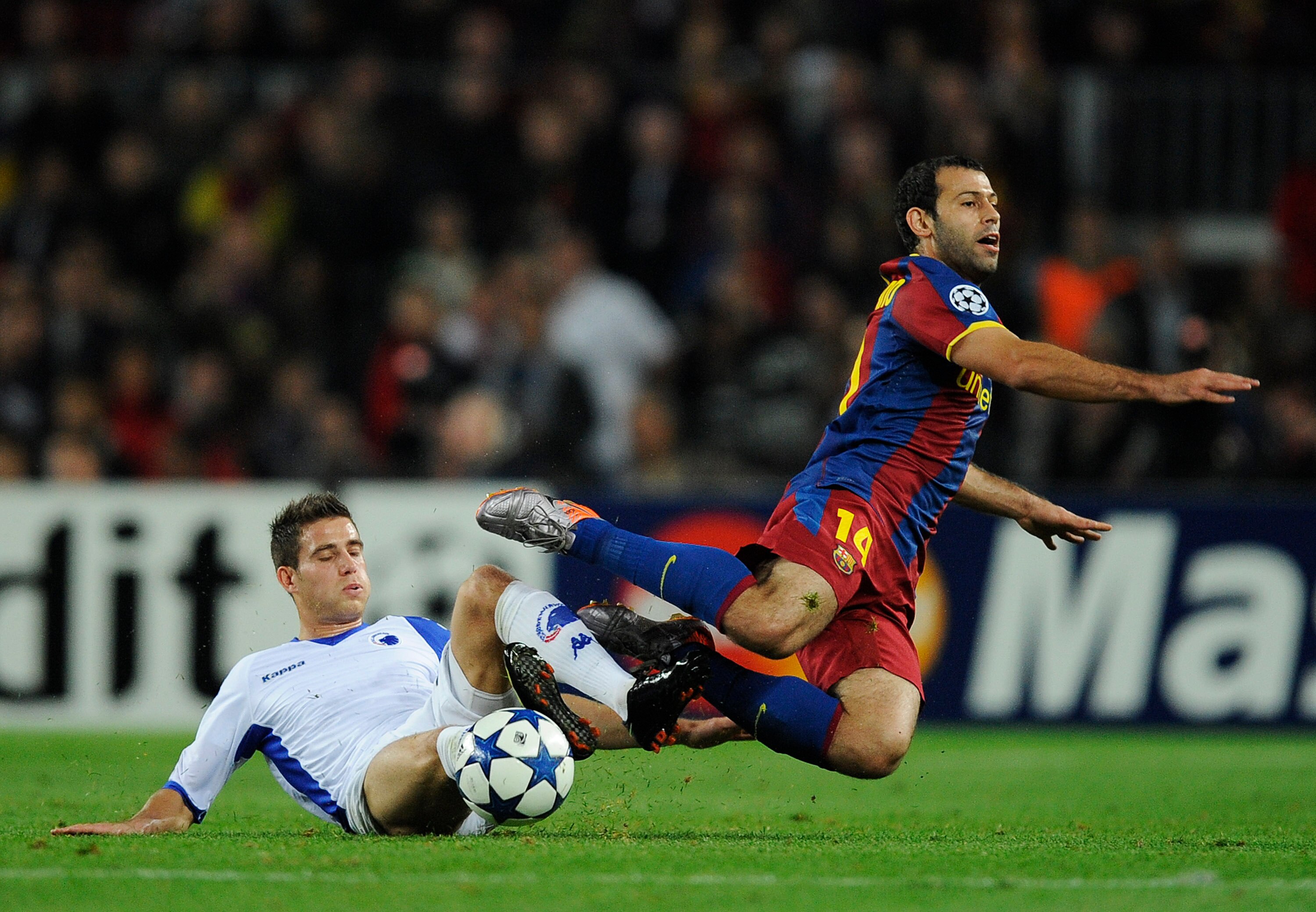 BARCELONA, SPAIN - OCTOBER 20:  Martin Vingaard of FC Copenhagen (L) and Javier Mascherano of Barcelona duels for a ball during the UEFA Champions League group D match between Barcelona and FC Copenhagen at the Camp nou stadium on October 20, 2010 in Barc