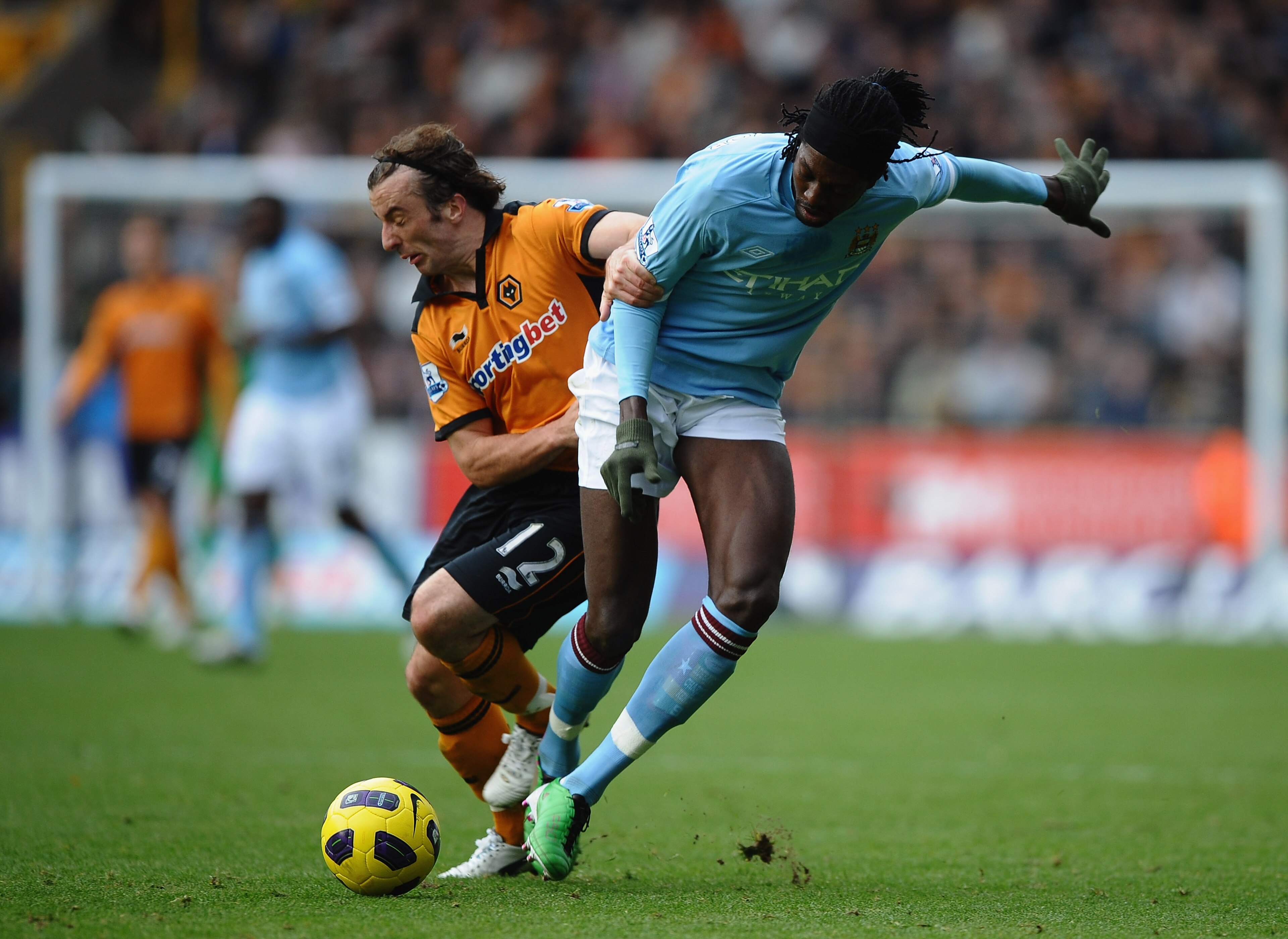 WOLVERHAMPTON, ENGLAND - OCTOBER 30: Emmanuel Adebayor of Manchester City battles with Stephen Hunt of Wolves during the Barclays Premier League match between Wolverhampton Wanderers and Manchester City at Molineux on October 30, 2010 in Wolverhampton, E WOLVERHAMPTON, ENGLAND - OCTOBER 30: Emmanuel Adebayor of Manchester City battles with Stephen Hunt of Wolves during the Barclays Premier League match between Wolverhampton Wanderers and Manchester City at Molineux on October 30, 2010 in Wolverhampton, E