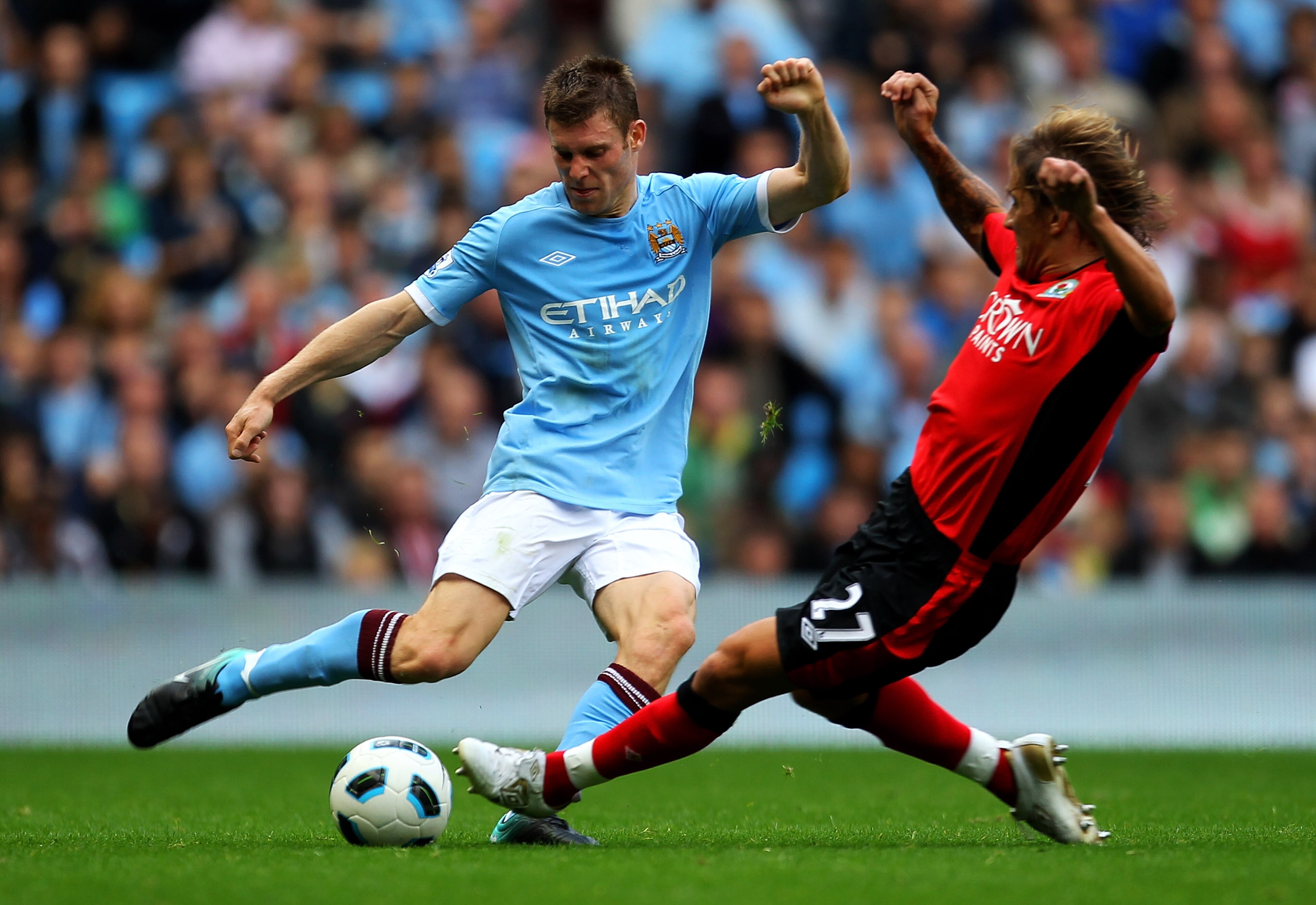 MANCHESTER, ENGLAND - SEPTEMBER 11: James Milner of Manchester City is challenged by Michel Salgado of Blackburn Rovers during the Barclays Premier League match between Manchester City and Blackburn Rovers at the City of Manchester Stadium on September 1 MANCHESTER, ENGLAND - SEPTEMBER 11: James Milner of Manchester City is challenged by Michel Salgado of Blackburn Rovers during the Barclays Premier League match between Manchester City and Blackburn Rovers at the City of Manchester Stadium on September 1
