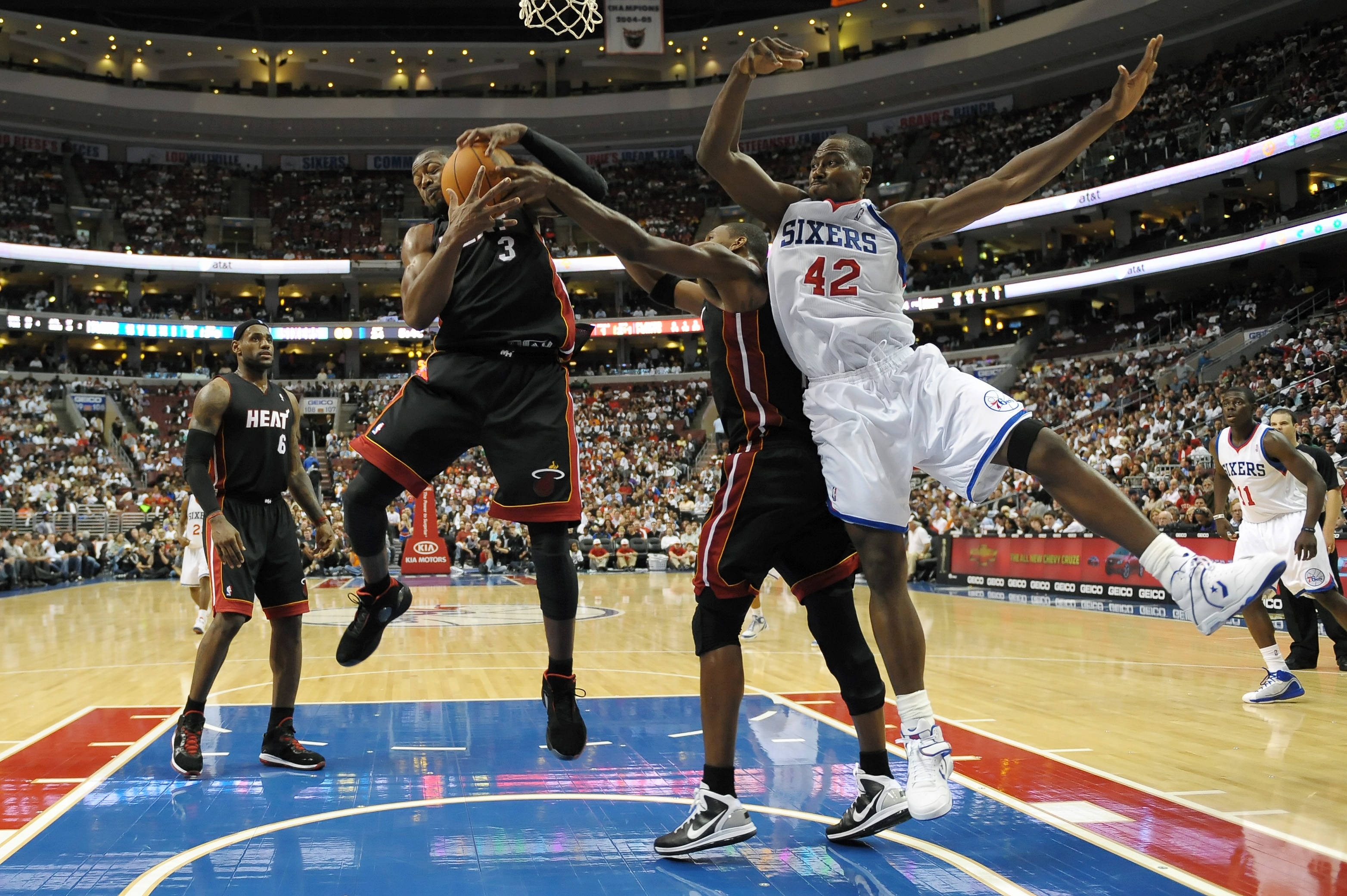 PHILADELPHIA - OCTOBER 27:  Dwyane Wade #3 of the Miami Heat grabs a rebound away from Elton Brand #42 of the Philadelphia 76ers at the Wells Fargo Center on October 27, 2010 in Philadelphia, Pennsylvania. NOTE TO USER: User expressly acknowledges and agr