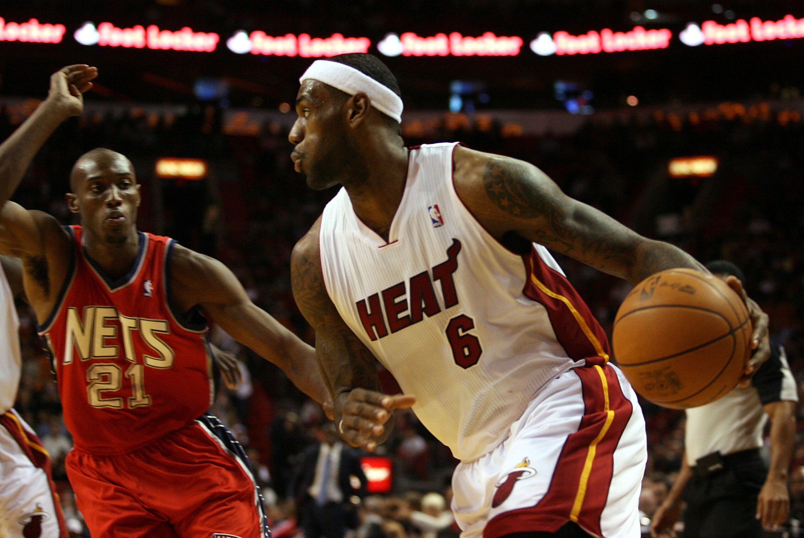 MIAMI - NOVEMBER 06: Forward LeBron James #6 of the Miami Heat drives againstTravis Outlaw #21 of the New Jersey Nets at American Airlines Arena on November 6, 2010 in Miami, Florida. NOTE TO USER: User expressly acknowledges and agrees that, by downlo MIAMI - NOVEMBER 06: Forward LeBron James #6 of the Miami Heat drives againstTravis Outlaw #21 of the New Jersey Nets at American Airlines Arena on November 6, 2010 in Miami, Florida. NOTE TO USER: User expressly acknowledges and agrees that, by downlo
