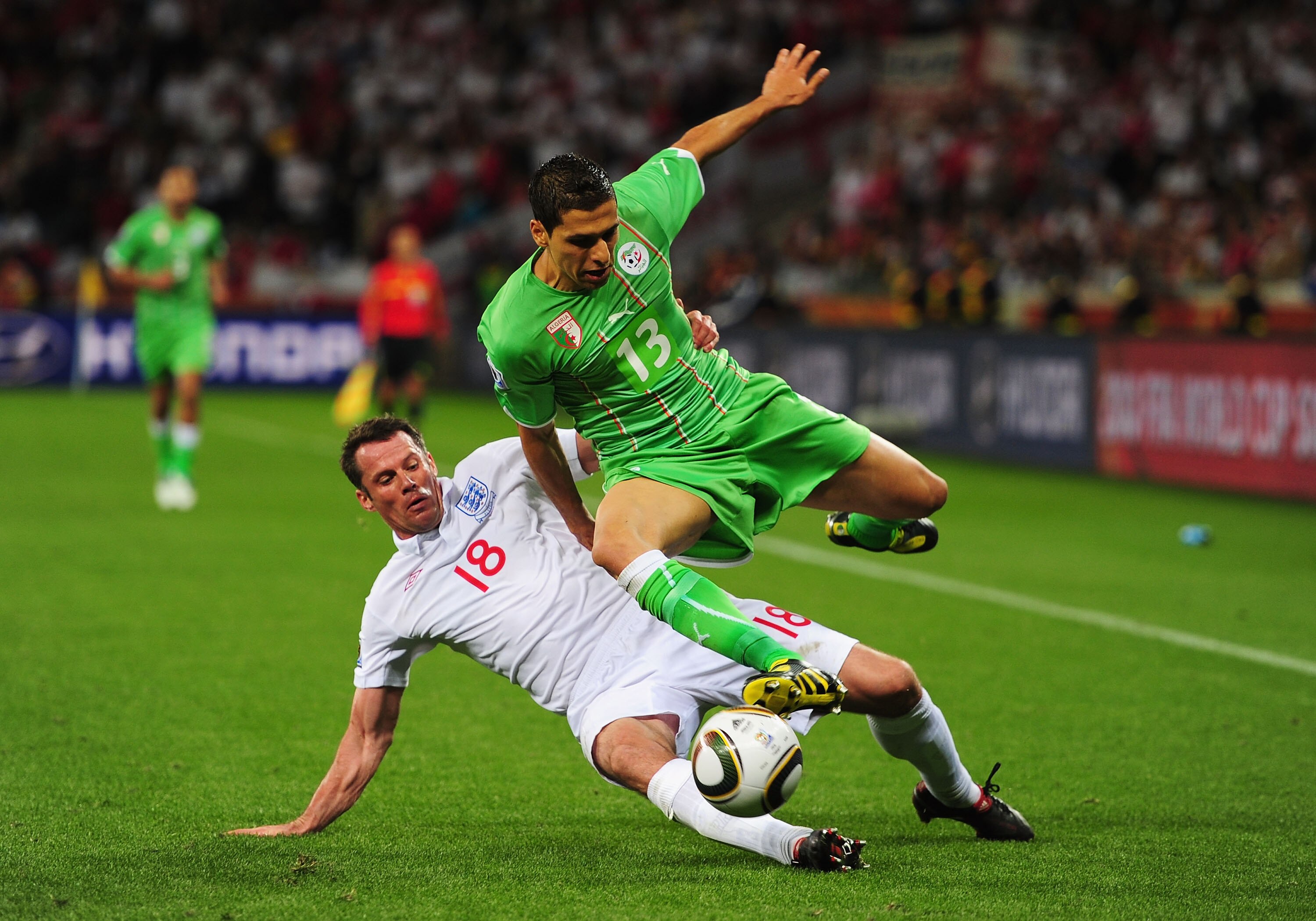 CAPE TOWN, SOUTH AFRICA - JUNE 18:  Jamie Carragher of England tackles Karim Matmour of Algeria during the 2010 FIFA World Cup South Africa Group C match between England and Algeria at Green Point Stadium on June 18, 2010 in Cape Town, South Africa.  (Pho