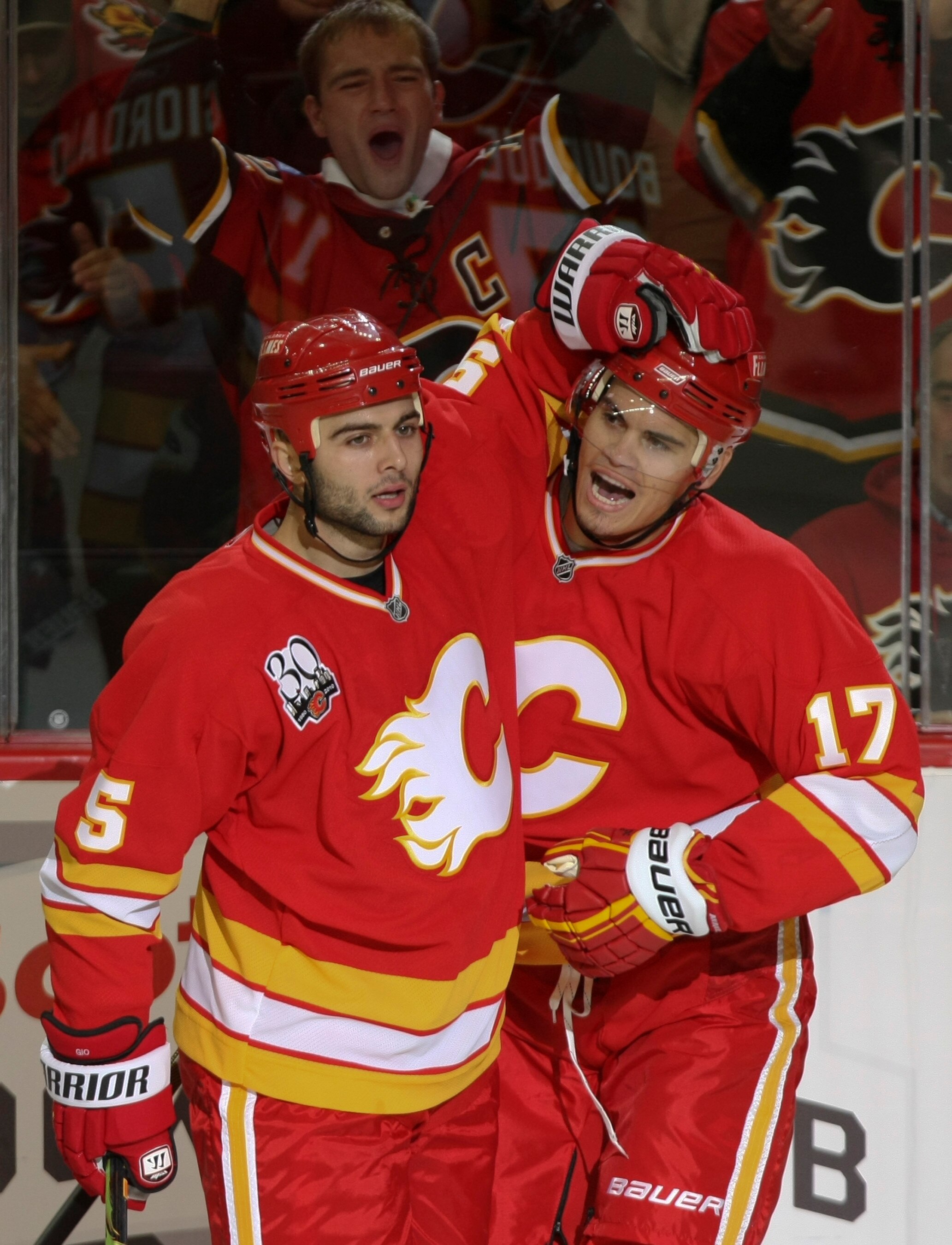 CALGARY, AB - OCTOBER 1: Rene Bourque #17 of the Calgary Flames celebrates his goal with teammate Mark Giordano #5 against the Vancouver Canucks in the first period of NHL action on October 1, 2009 at the Pengrowth Saddledome in Calgary, Alberta, Canada.