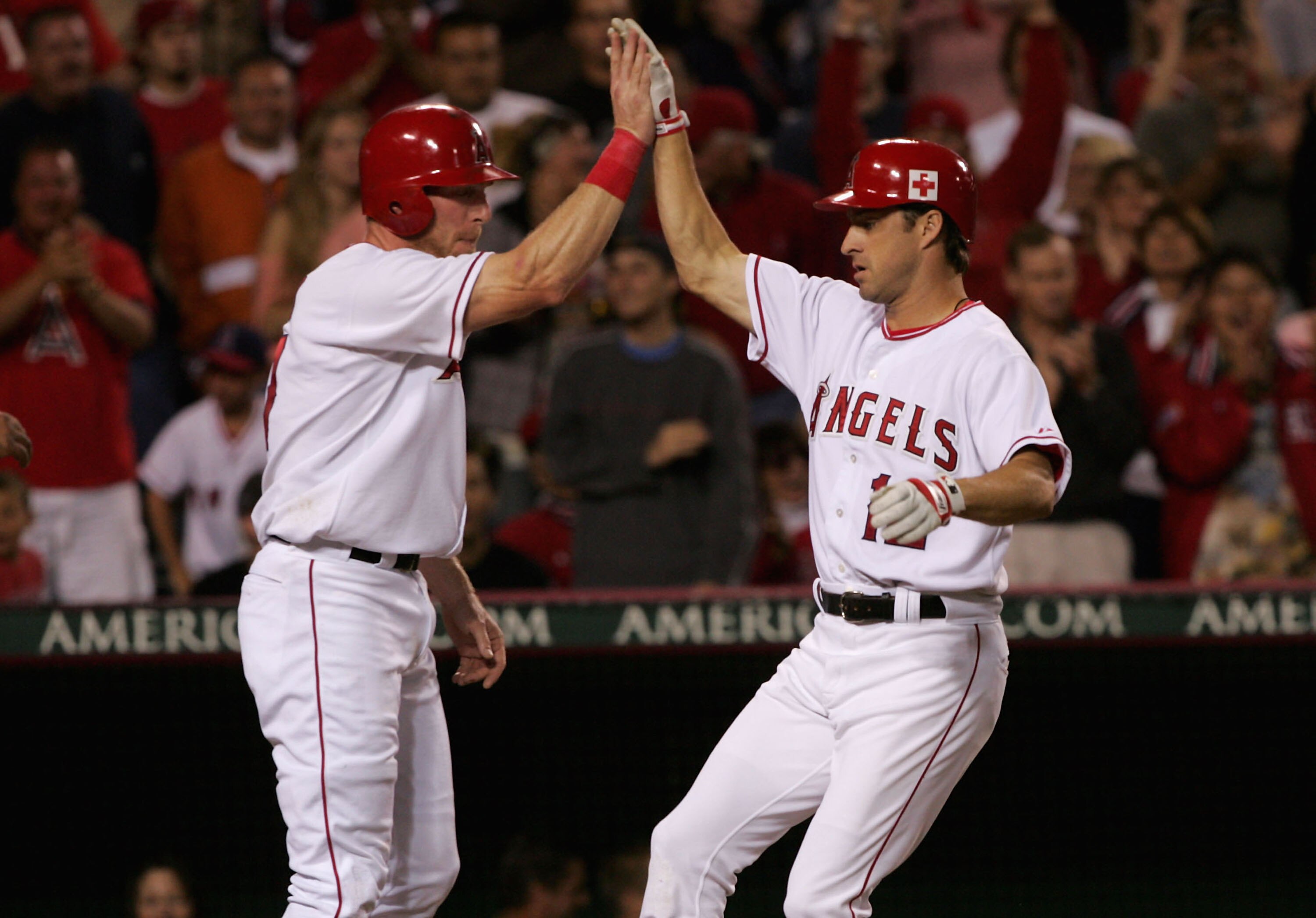 ANAHEIM, CA - SEPTEMBER 24:  Steve Finley #12 (R) of the Los Angeles Angels of Anaheim is greeted by Darin Erstad #17 at home plate after Finley's three run home run in the second inning against the Tampa Bay Devil Rays on September 24, 2005 at Angel Stad
