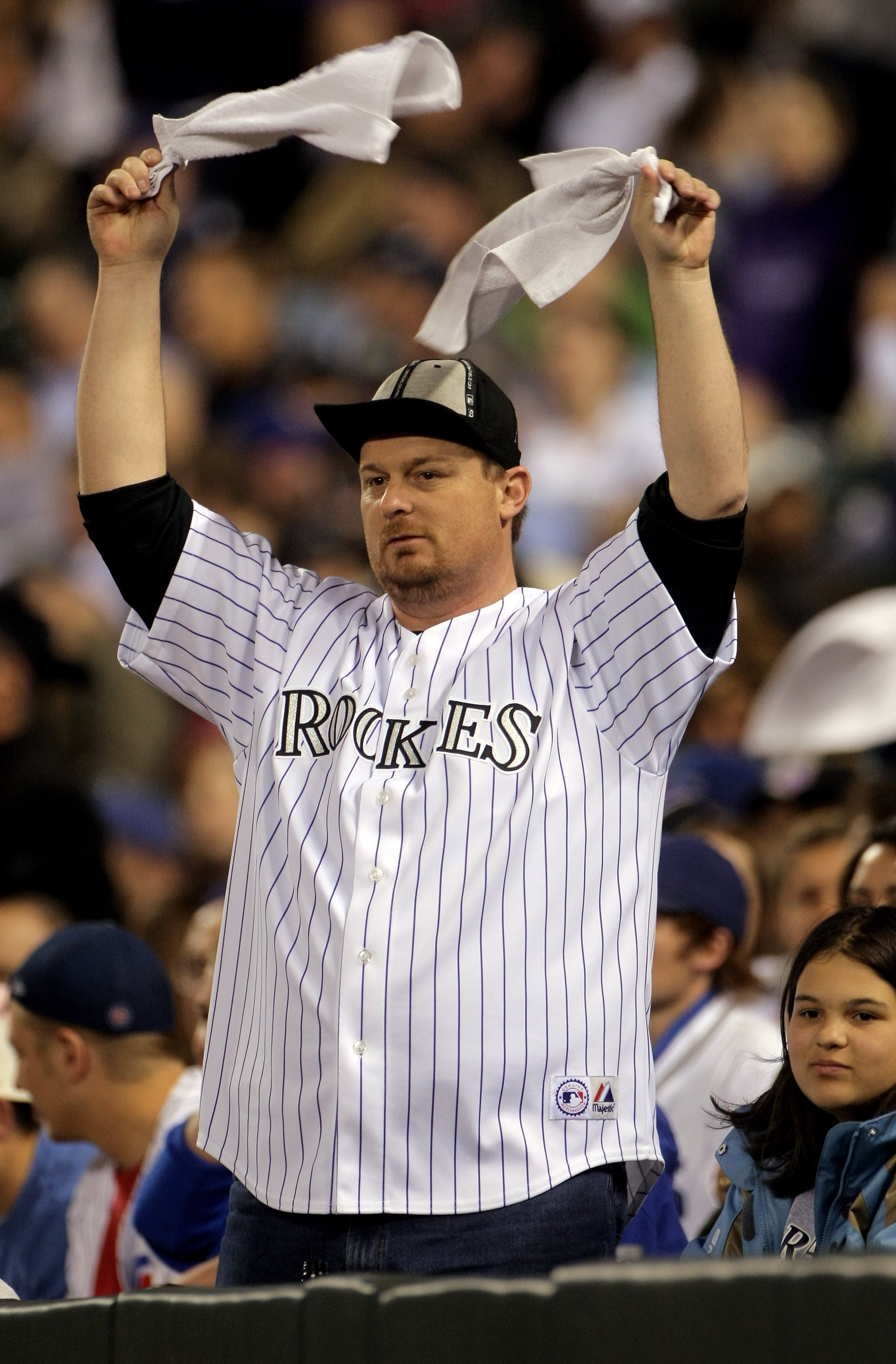 DENVER - APRIL 23:  A fan of the Colorado Rockies  employees several stategies including the rally cap and duel towels to no avail against the Chicago Cubs at Coors Field on April 23, 2008 in Denver, Colorado. The Cubs defeated the Rockies 7-6 in 10 innin