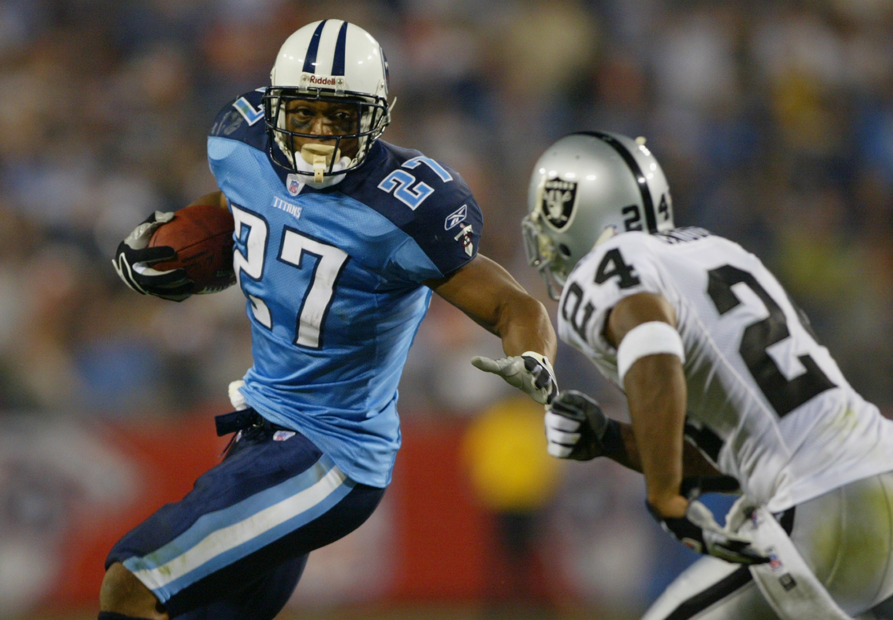 NASHVILLE, TN - SEPTEMBER 7:  Charles Woodson #24 of the Oakland Raiders goes after Eddie George #27 of the Tennessee Titans on September 7, 2003 at the The Coliseum in Nashville, Tennessee. The Titans defeated the Raiders 25-20. (Photo by Jamie Squire/Ge