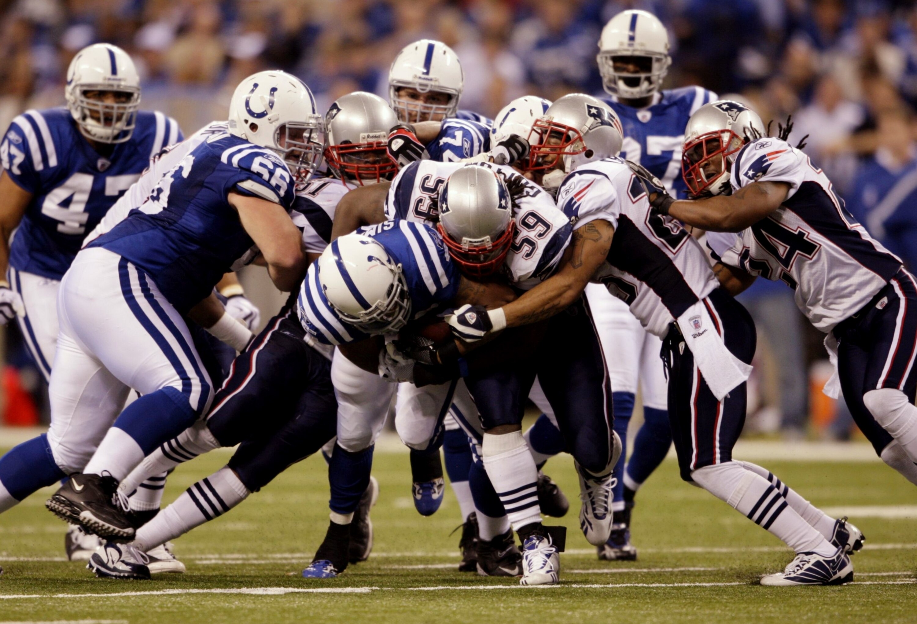 INDIANAPOLIS - NOVEMBER 15:  Chad Simpson #35 of the Indianapolis Colts holds on to the ball against Gary Guyton #59 of the New England Patriots during the game at Lucas Oil Stadium on November 15, 2009 in Indianapolis, Indiana.  (Photo by Andy Lyons/Gett