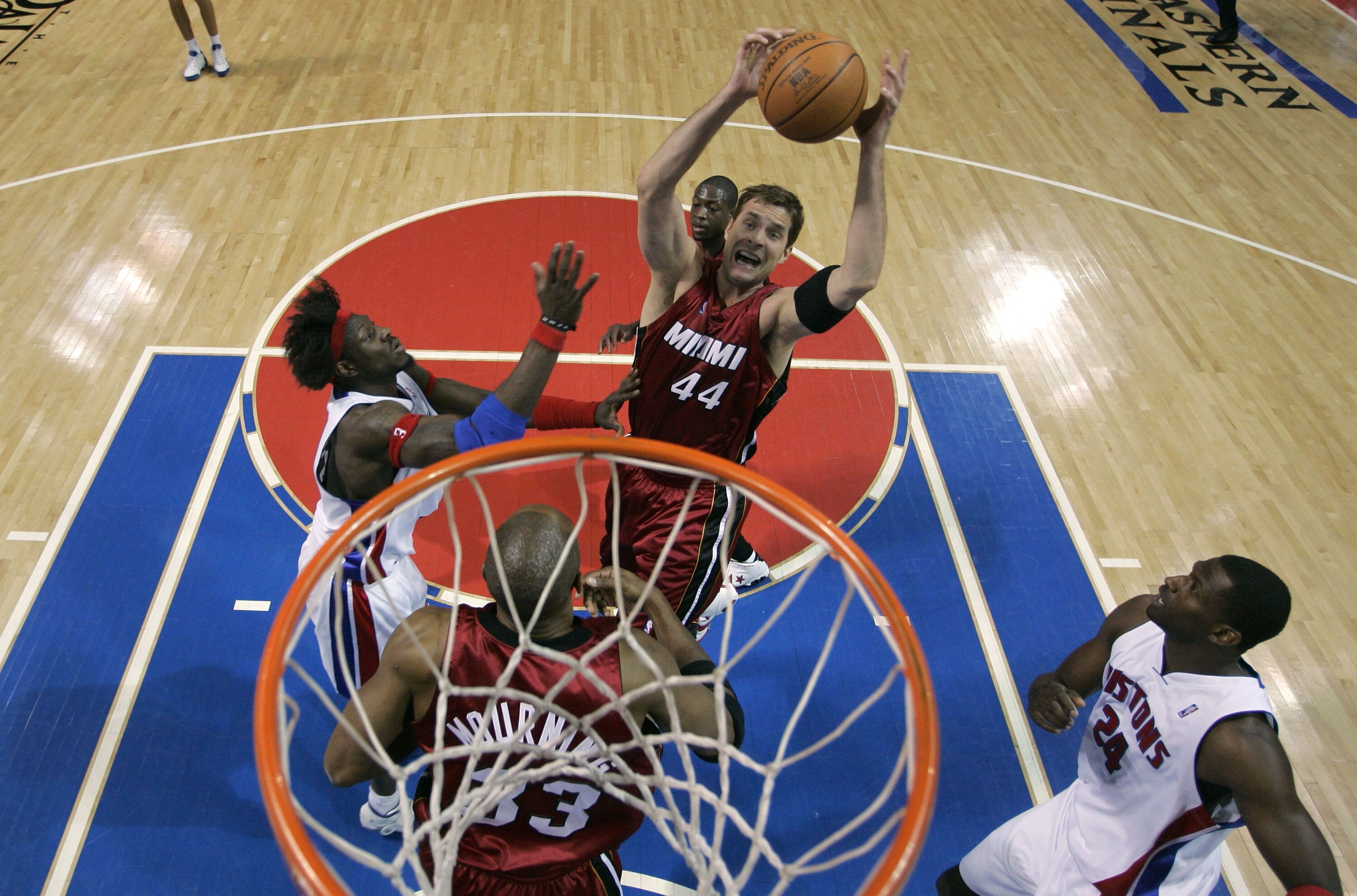 AUBURN HILLS, MI - MAY 29:  Christian Laettner #44 of the Miami Heat grabs a rebound against Ben Wallace #3 (L) and Antonio McDyess #24 of the Detroit Pistons against the Miami Heat in Game Three of the Eastern Conference Finals during the 2005 NBA Playof