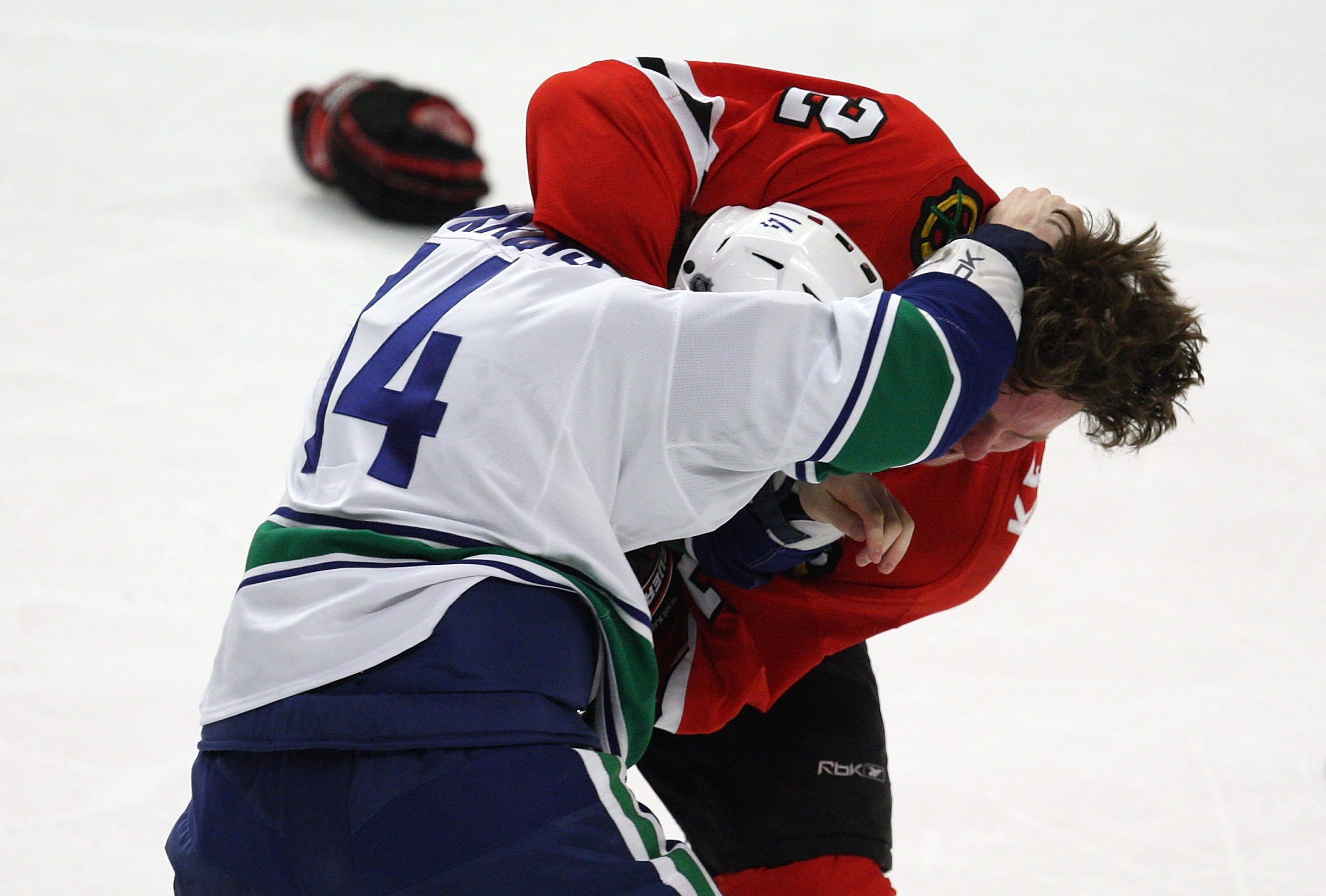 CHICAGO - MARCH 29: Duncan Keith #2 of the Chicago Blackhawks and Alex Burrows #14 of the Vancouver Canucks fight in the third period on March 29, 2009 at the United Center in Chicago, Illinois. The Canucks defeated the Blackhawks 4-0. (Photo by Jonathan