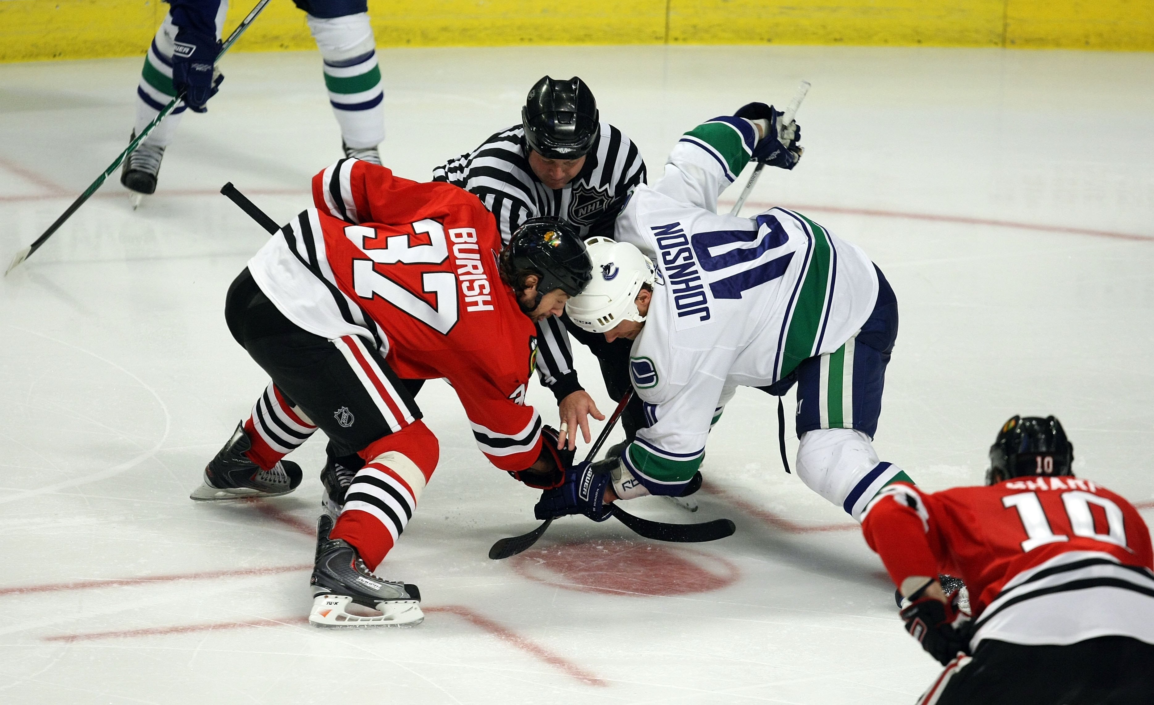CHICAGO - MAY 11:  Adam Burish #37 of the Chicago Blackhawks fights for control of a faceoff against Ryan Johnson #10 of the Vancouver Canucks during Game Six of the Western Conference Semifinal Round of the 2009 Stanley Cup Playoffs on May 11, 2009 at th
