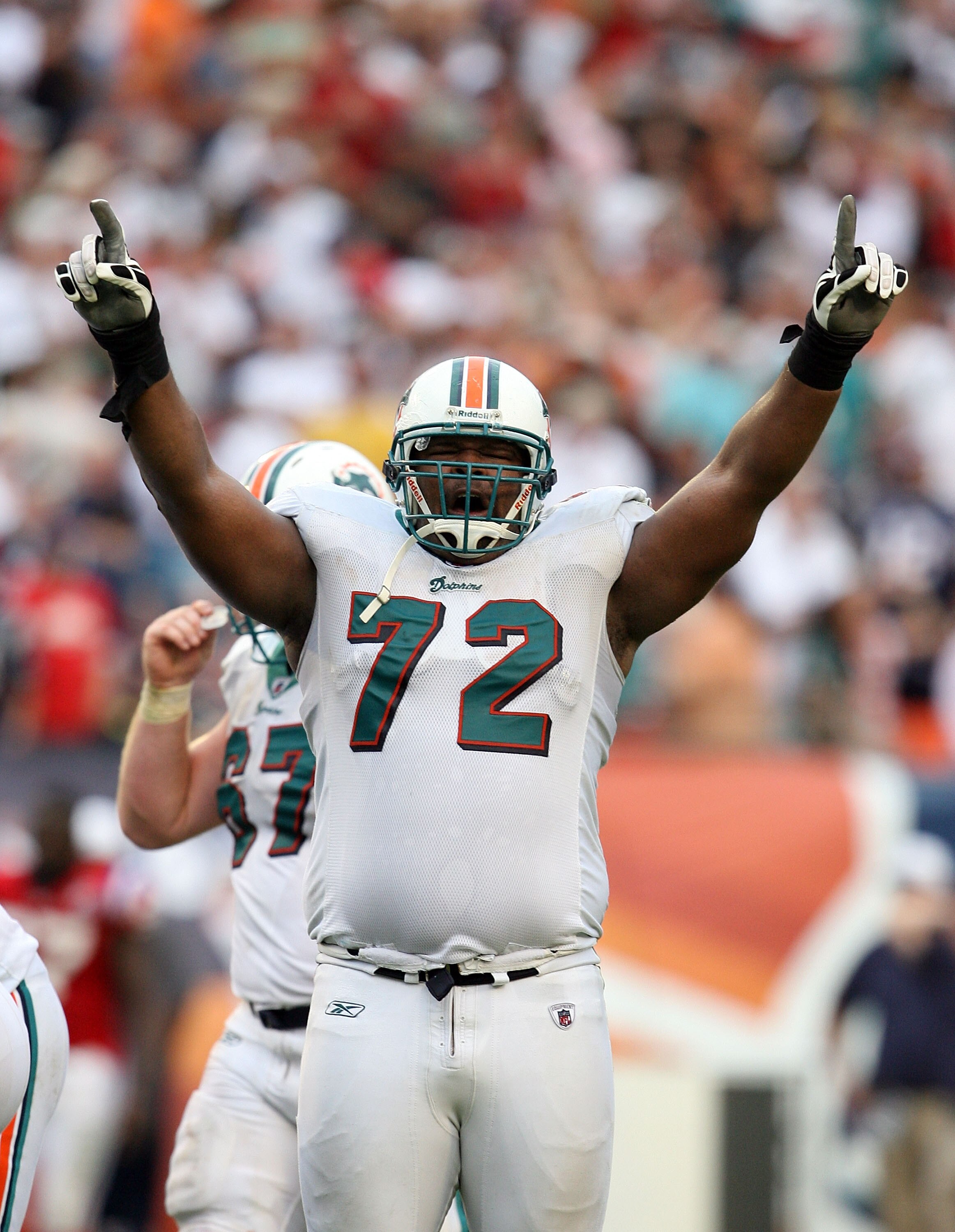 MIAMI - DECEMBER 06:  Tackle Vernon Carey #72 of the Miami Dolphins celebrates after linebacker Channing Crowder #52 intercepted quarterback Tom Brady #12 of the New England Patriots at Land Shark Stadium on December 6, 2009 in Miami, Florida. The Dolphin