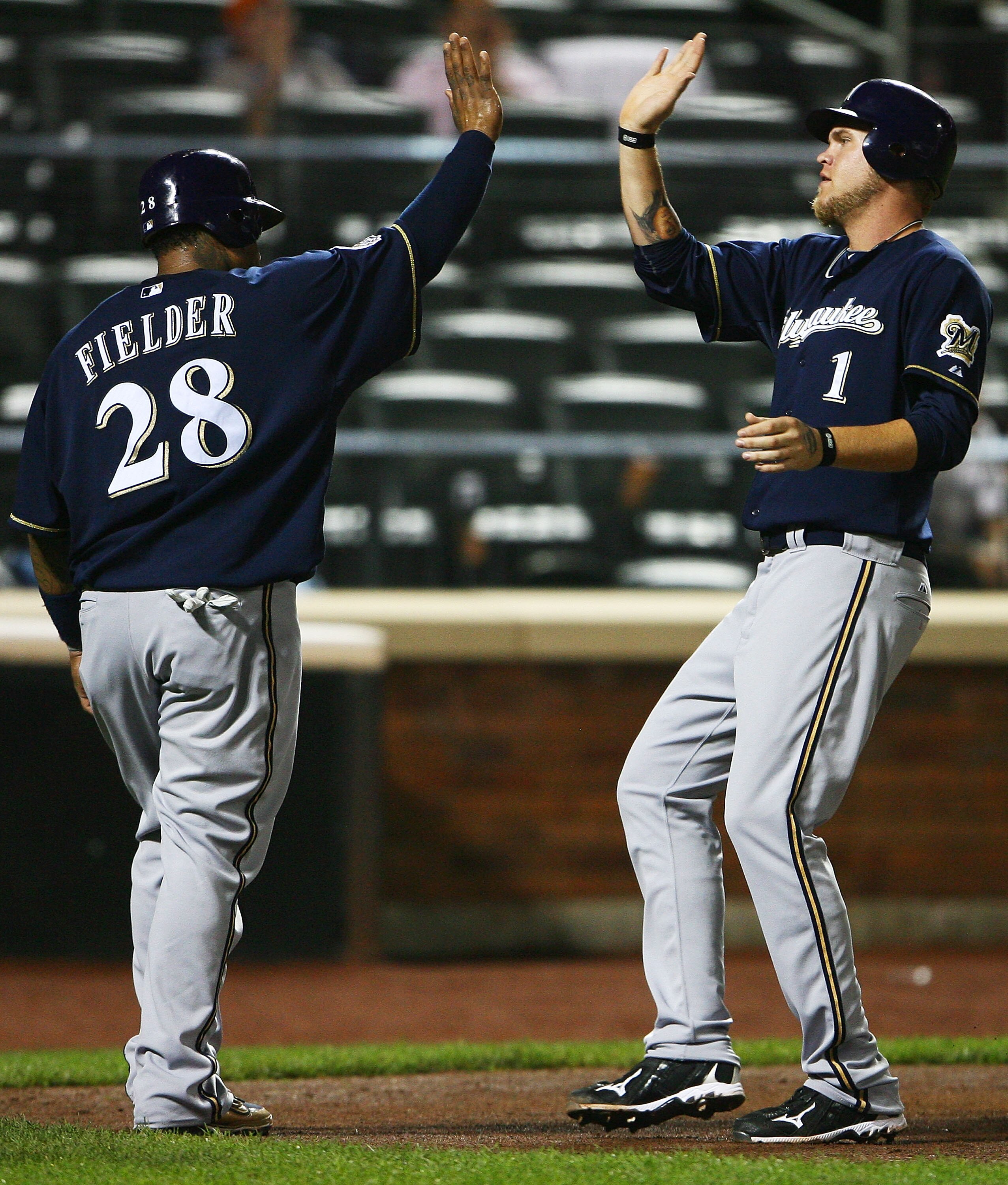 NEW YORK - SEPTEMBER 30:  Prince Fielder #28 (L) and Corey Hart #1 of the Milwaukee Brewers celebrate after both scoring off Lorenzo Cain's double in the fifth inning against the New York Mets on September 30, 2010 at Citi Field in the Flushing neighborho