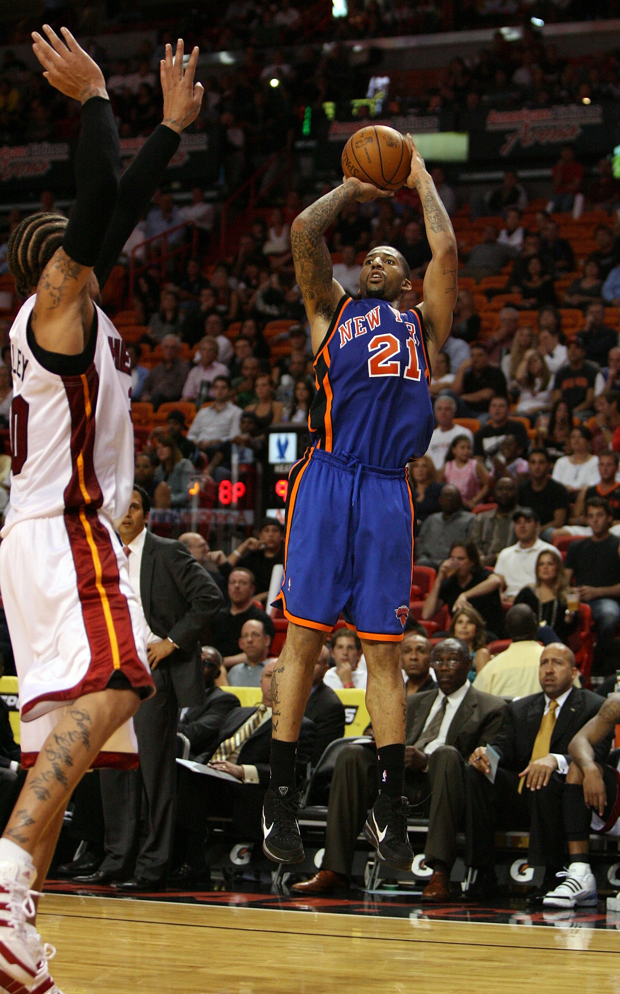 MIAMI - OCTOBER 28:  Wilson Chandler #21 of the New York Knicks shoots over Udonis Haslem #40 of the Miami Heat at AmericanAirlines Arena on October 28, 2009 in Miami, Florida. The Heat defeated the Knicks 115-93. NOTE TO USER: User expressly acknowledges