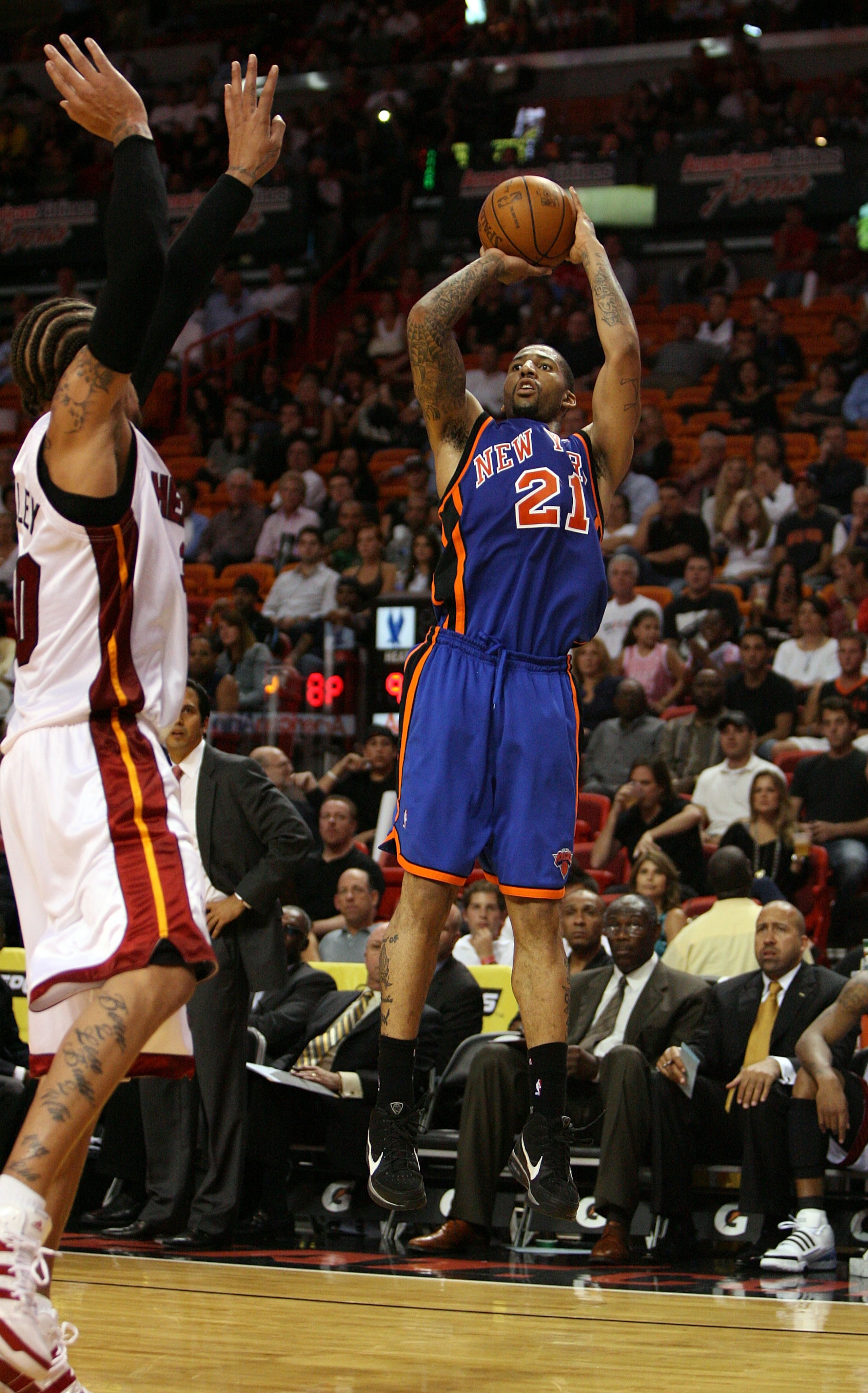 MIAMI - OCTOBER 28:  Wilson Chandler #21 of the New York Knicks shoots over Udonis Haslem #40 of the Miami Heat at AmericanAirlines Arena on October 28, 2009 in Miami, Florida. The Heat defeated the Knicks 115-93. NOTE TO USER: User expressly acknowledges