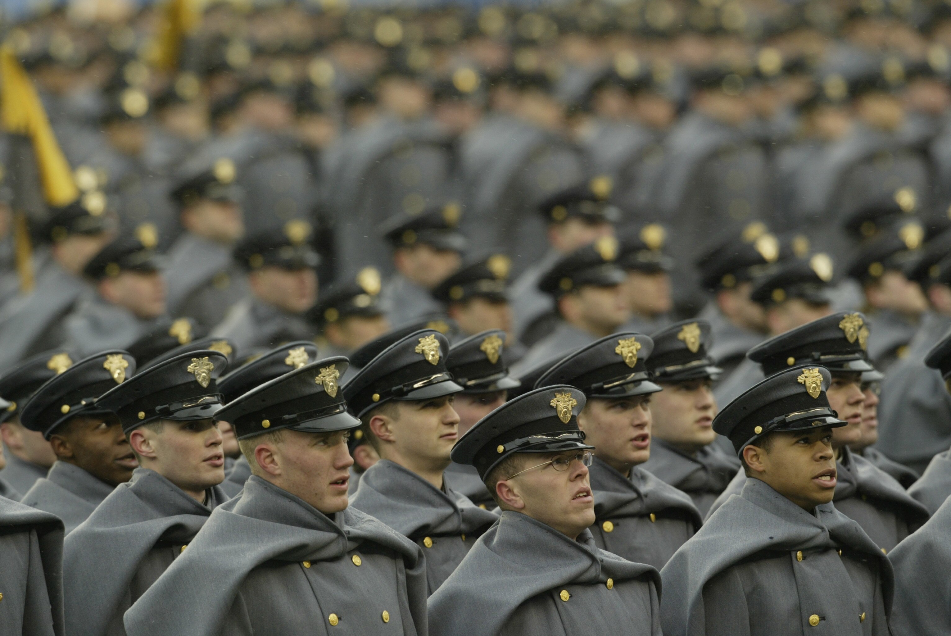 PHILADELPHIA - DECEMBER 6:  Army cadets watch the video board as they stand on the field before the game against the Navy at Lincoln Financial Field on December 6, 2003 in Philadelphia, Pennsylvania.  The Navy defeated the Army 34-6 making Army the first 