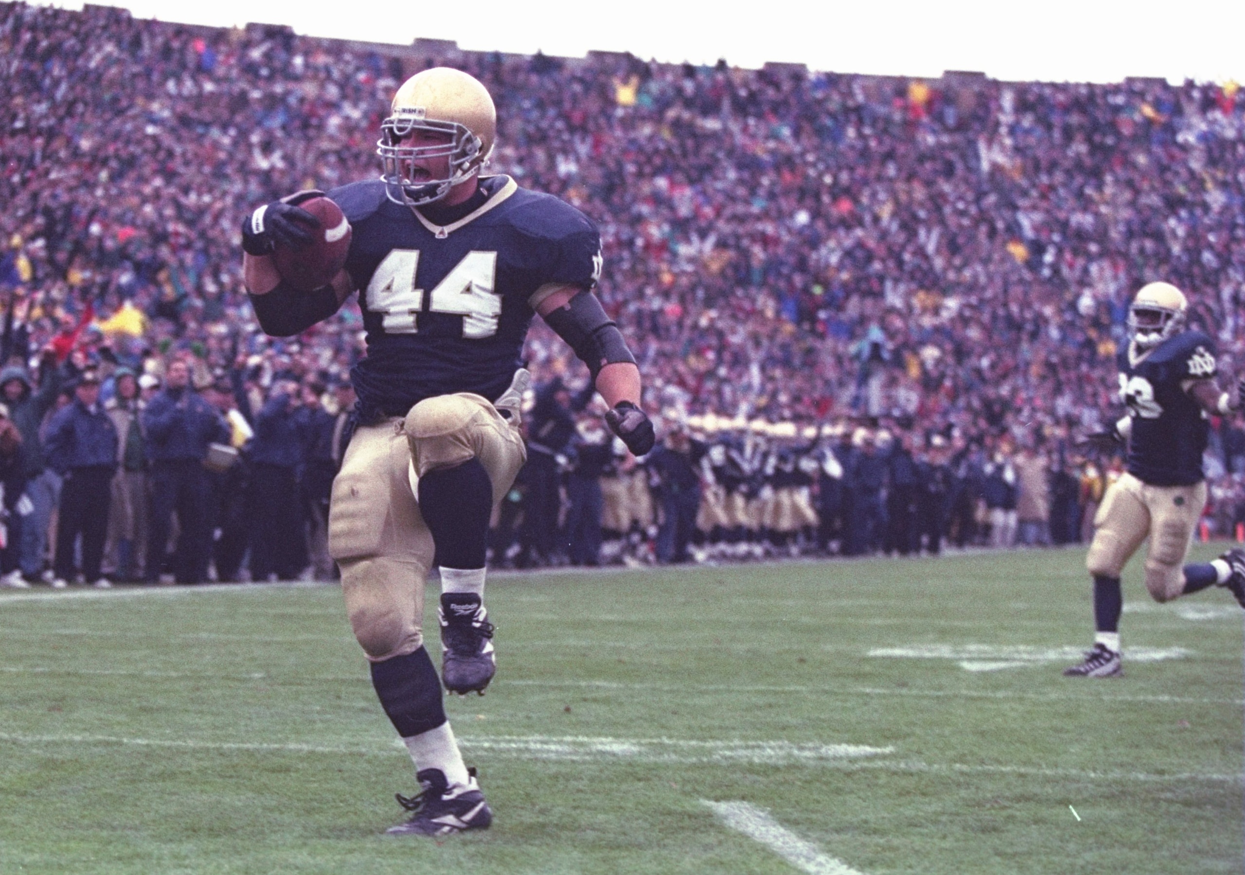 21 Oct 1995:  Fullback Marc Edwards of the Notre Dame Fighting Irish celebrates as he enters the end zone, scoring a touchdown, during the Fighting Irish's 38-10 victory over the USC Trojans at Notre Dame Stadium in South Bend, Indiana. Mandatory Credit:
