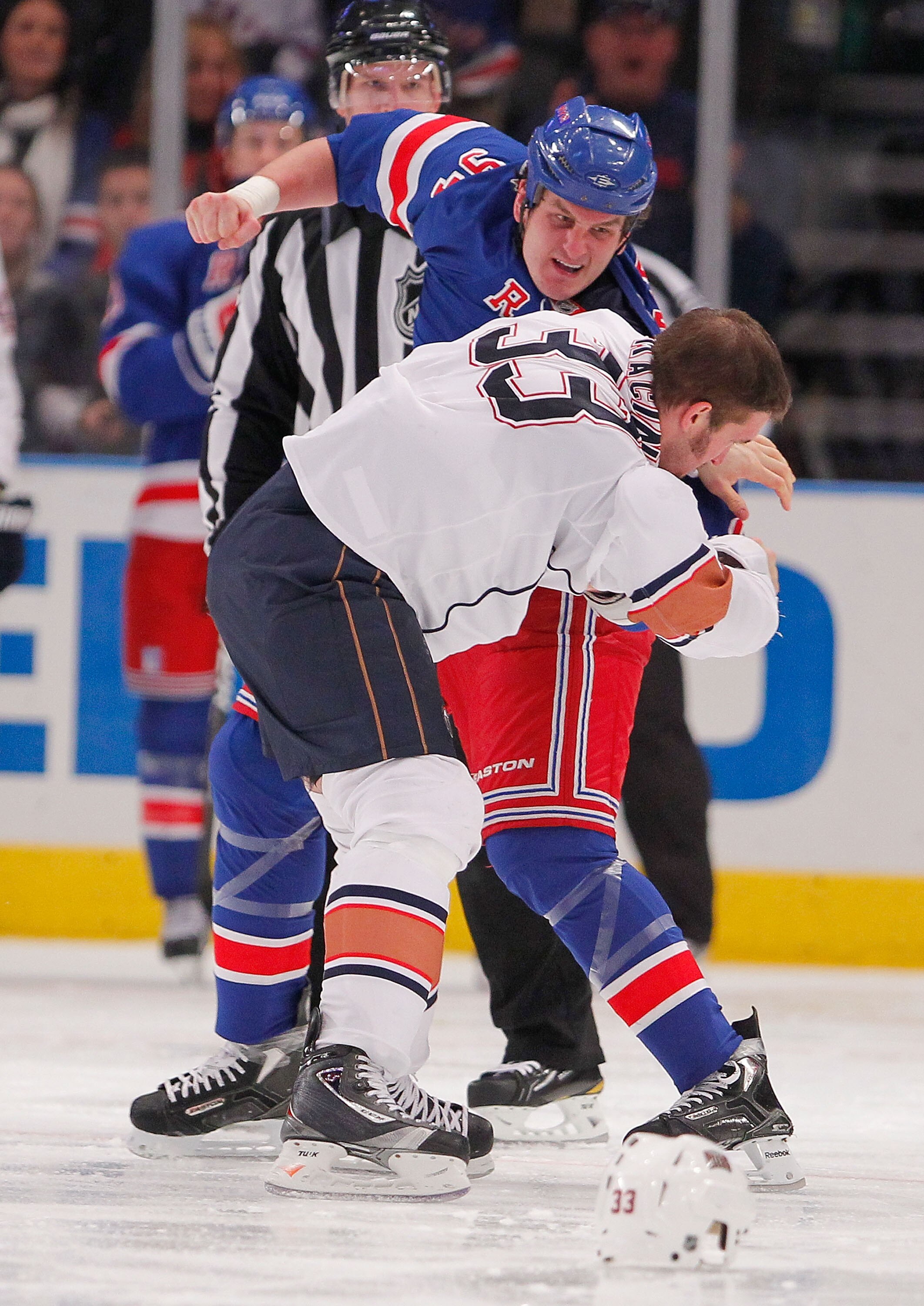 NEW YORK - NOVEMBER 14:  Steve MacIntyre #33 of the Edmonton Oilers fighting with Derek Boogaard #94 of the New York Rangers during a hockey game at Madison Square Garden on November 14, 2010 in New York City.  (Photo by Paul Bereswill/Getty Images)