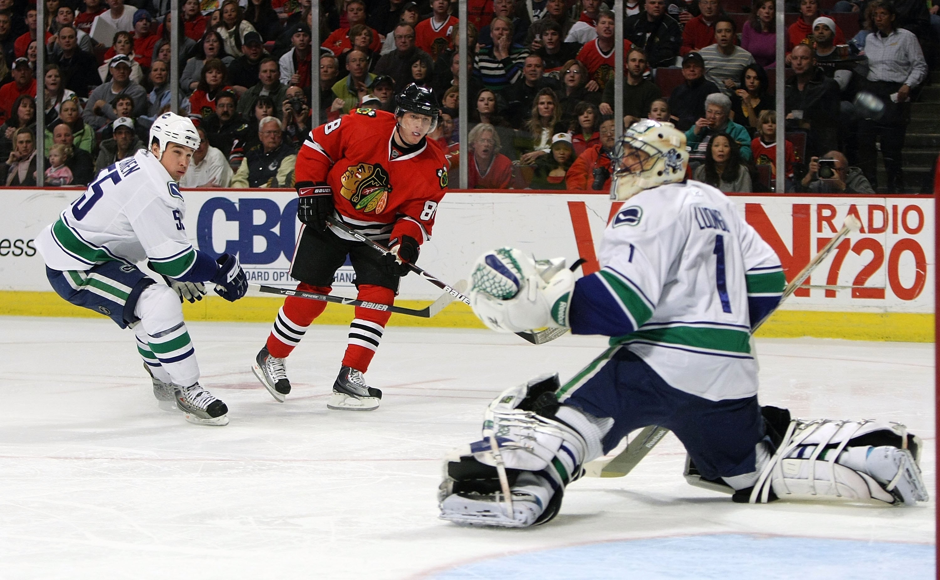 CHICAGO - MARCH 29: Patrick Kane #88 of the Chicago Blackhawks fires a shot past Shane O'Brien #55 of the Vancouver Canucks just missing Roberto Luongo #1 on March 29, 2009 at the United Center in Chicago, Illinois. The Canucks defeated the Blackhawks 4-0