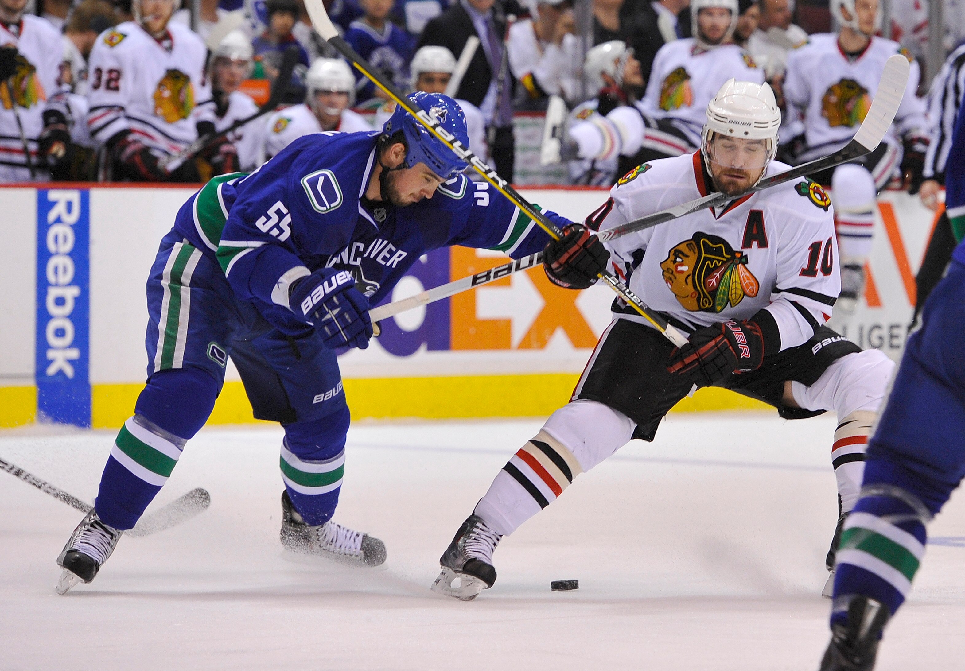 VANCOUVER, CANADA - MAY 11:  Shane O'Brien #55 of the Vancouver Canucks hits Patrick Sharp #10 of the Chicago Blackhawks with a high stick during the second period in Game Six of the Western Conference Semifinals during the 2010 NHL Stanley Cup Playoffs o
