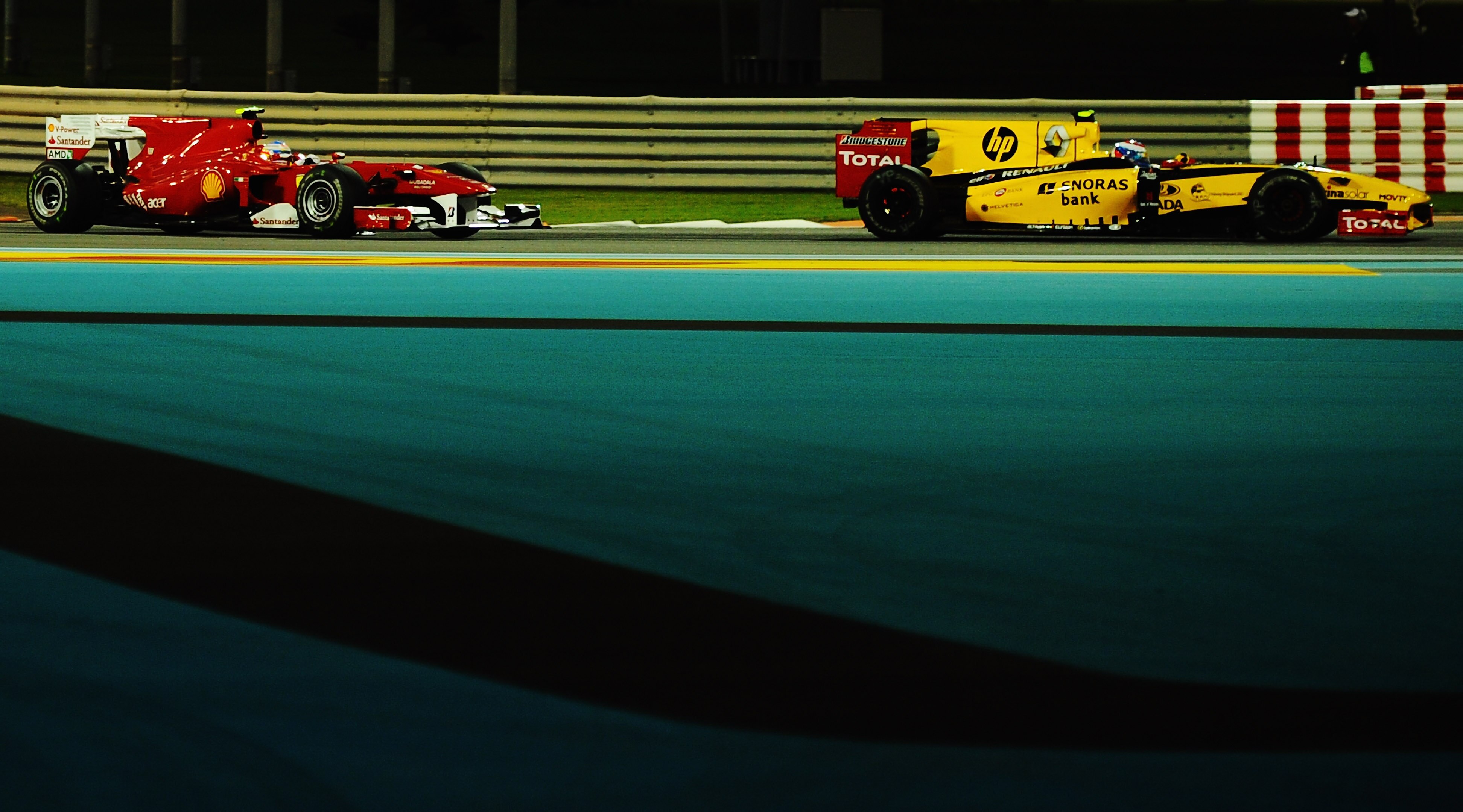 ABU DHABI, UNITED ARAB EMIRATES - NOVEMBER 14:  Vitaly Petrov of Russia and Renault leads from Fernando Alonso of Spain and Ferrari during the Abu Dhabi Formula One Grand Prix at the Yas Marina Circuit on November 14, 2010 in Abu Dhabi, United Arab Emirat