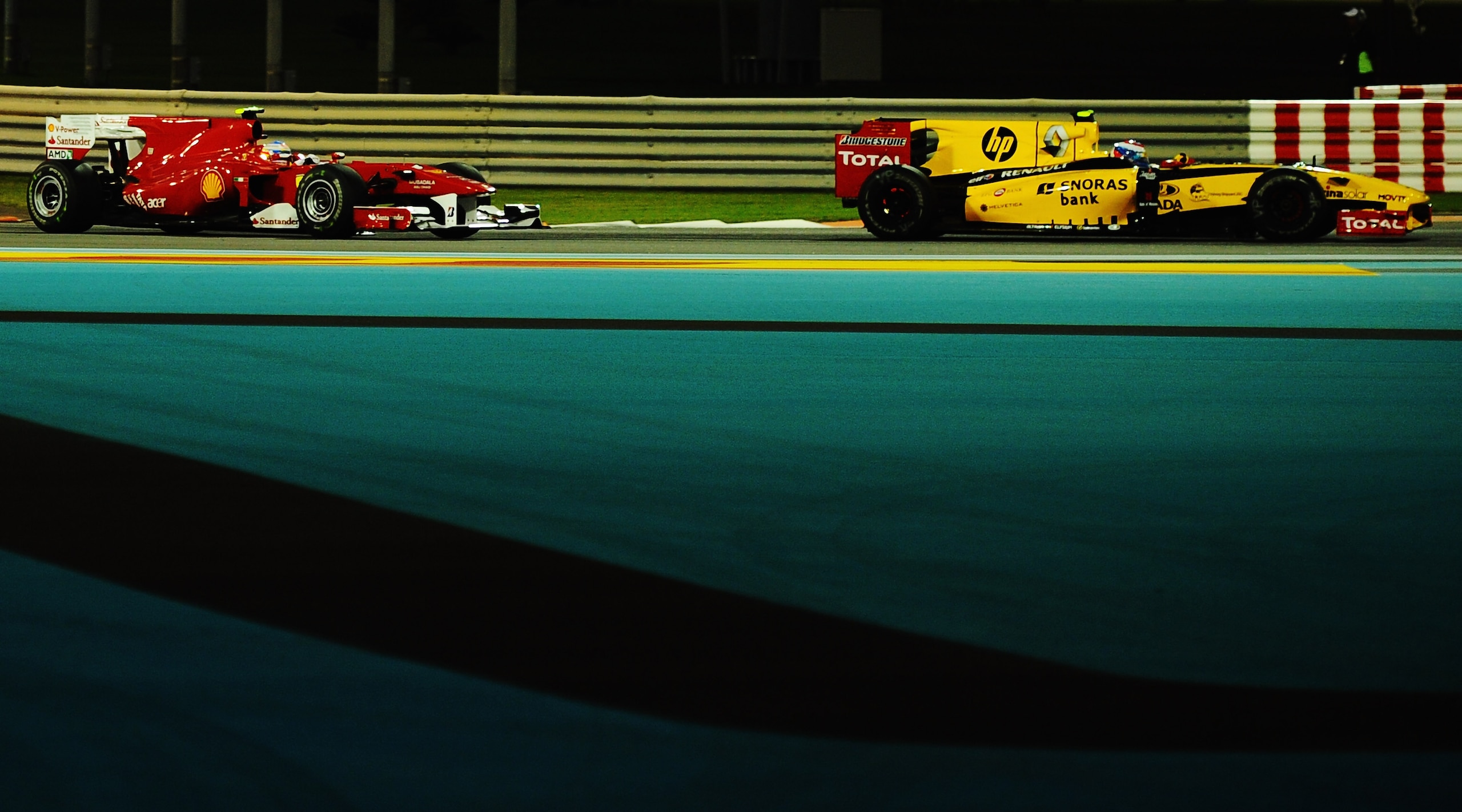 ABU DHABI, UNITED ARAB EMIRATES - NOVEMBER 14:  Vitaly Petrov of Russia and Renault leads from Fernando Alonso of Spain and Ferrari during the Abu Dhabi Formula One Grand Prix at the Yas Marina Circuit on November 14, 2010 in Abu Dhabi, United Arab Emirat