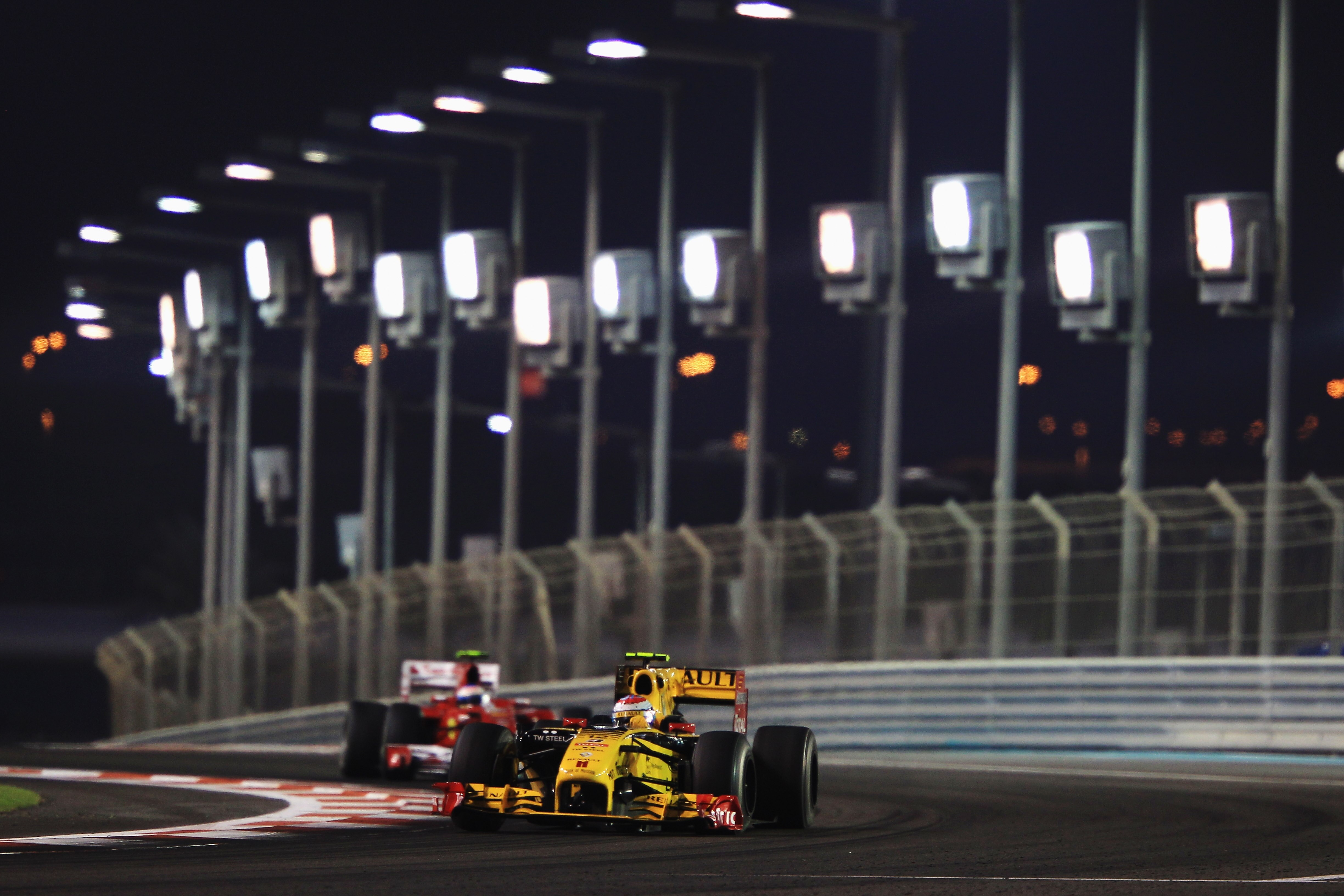 ABU DHABI, UNITED ARAB EMIRATES - NOVEMBER 14:  Vitaly Petrov of Russia and Renault leads from Fernando Alonso of Spain and Ferrari during the Abu Dhabi Formula One Grand Prix at the Yas Marina Circuit on November 14, 2010 in Abu Dhabi, United Arab Emirat