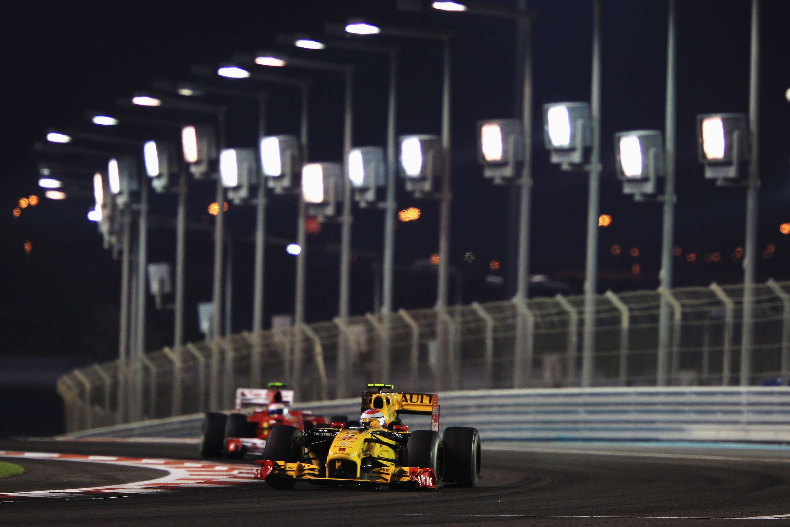 ABU DHABI, UNITED ARAB EMIRATES - NOVEMBER 14:  Vitaly Petrov of Russia and Renault leads from Fernando Alonso of Spain and Ferrari during the Abu Dhabi Formula One Grand Prix at the Yas Marina Circuit on November 14, 2010 in Abu Dhabi, United Arab Emirat