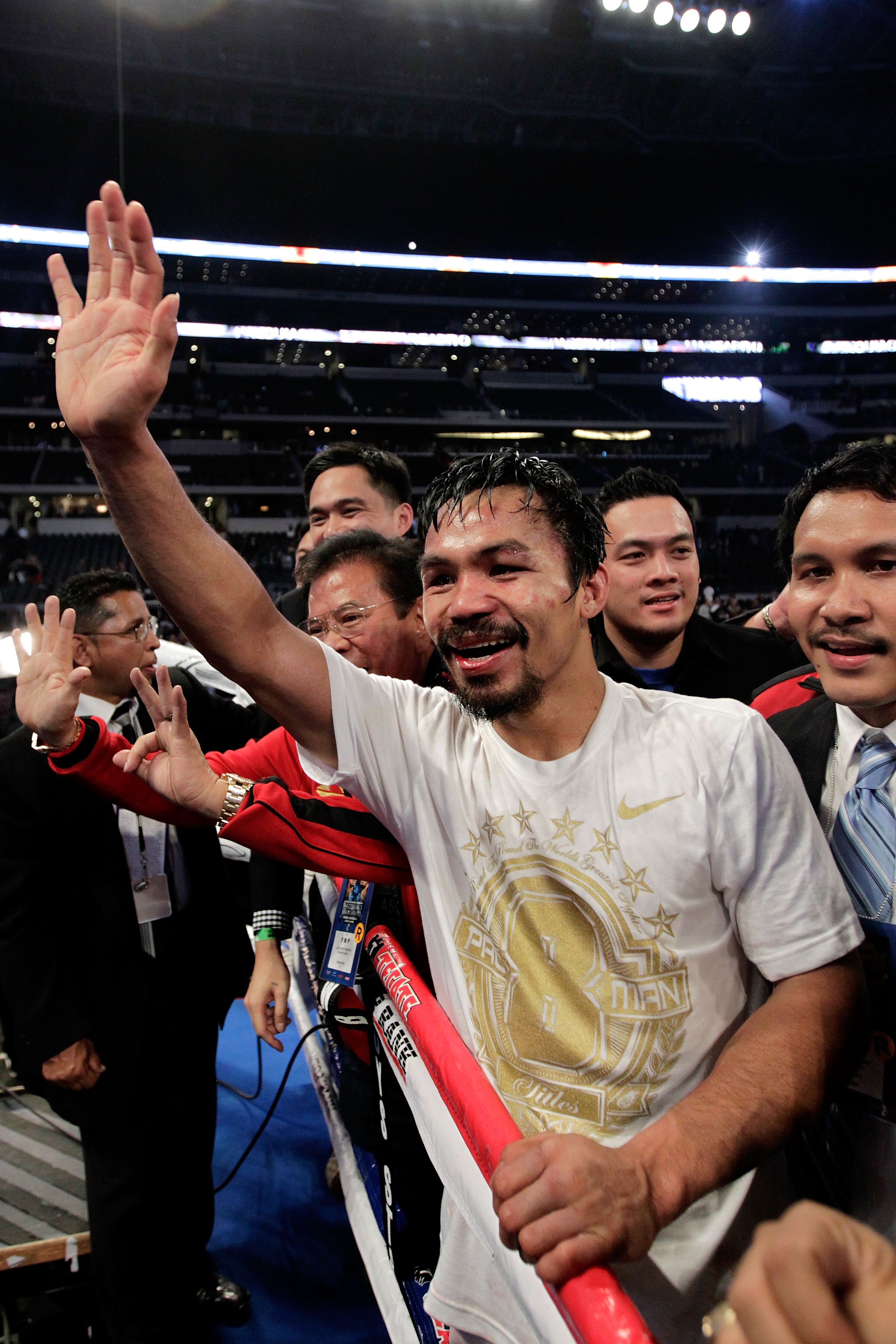 ARLINGTON, TX - NOVEMBER 13:  Manny Pacquiao (white trunks) of the Philippines celebrates after he was declared the winner by a unanimous decision against Antonio Margarito (black trunks) of Mexico during their WBC World Super Welterweight Title bout at C