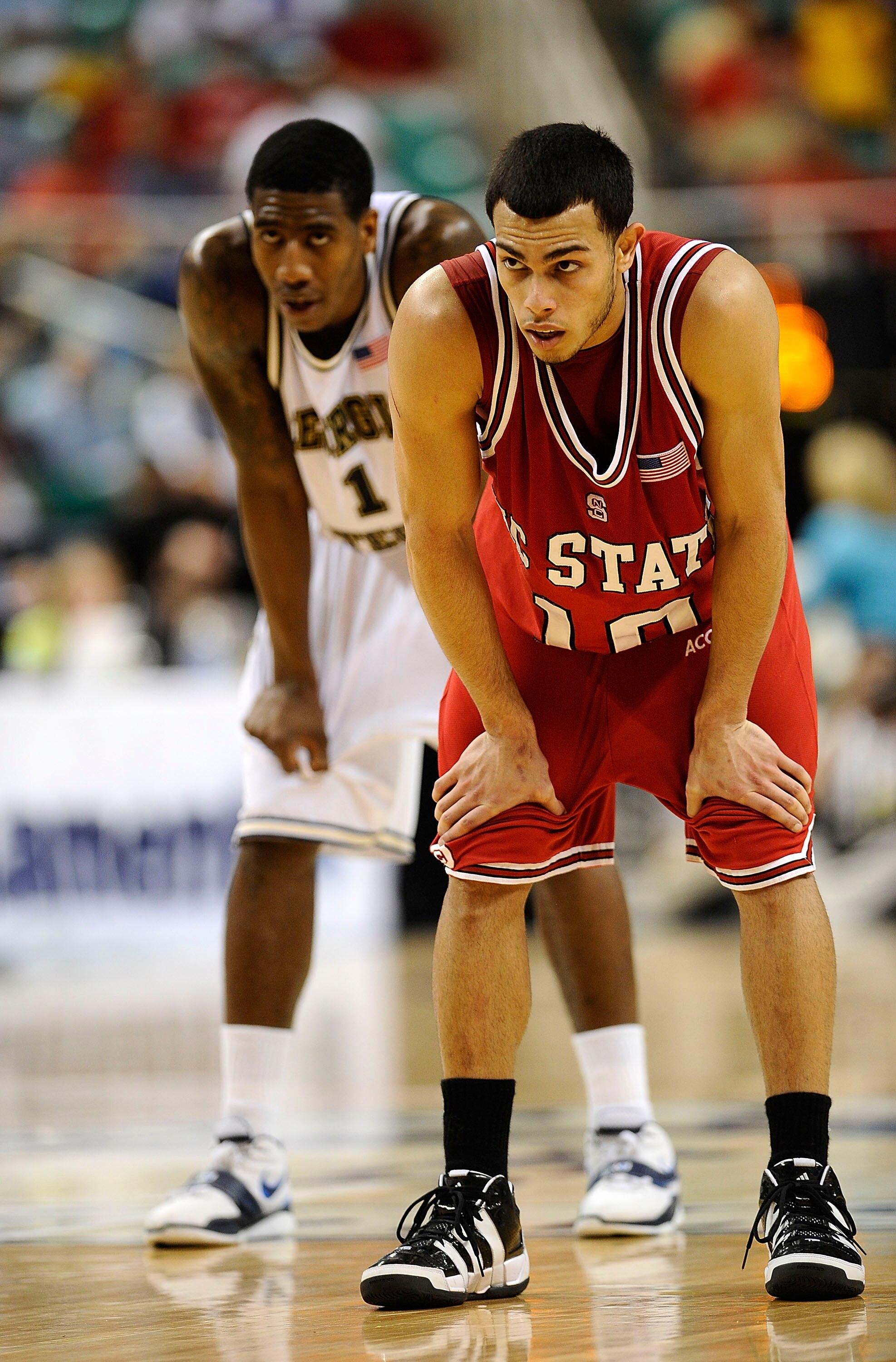 GREENSBORO, NC - MARCH 13:  Iman Shumpert #1 of the Georgia Tech Yellow Jackets stands behind Javier Gonzalez #10 of the North Carolina State Wolfpack in their semifinal game in the 2010 ACC Men's Basketball Tournament at the Greensboro Coliseum on on Mar