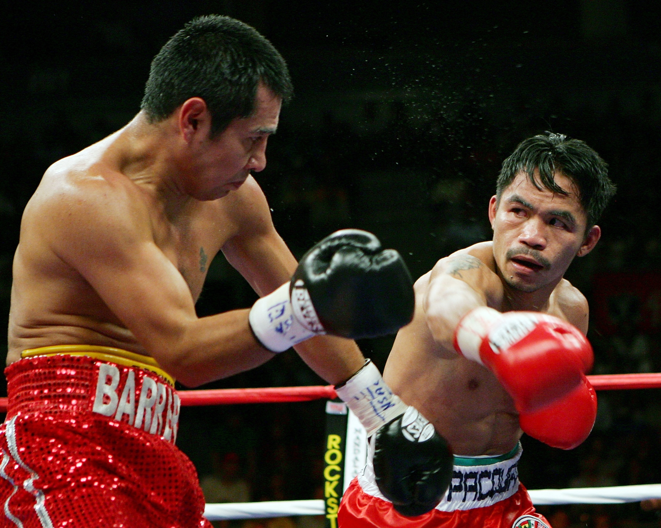 LAS VEGAS - OCTOBER 06:  Marco Antonio Barrera (L) and Manny Pacquiao trade punches in the fifth round of their 12-round super featherweight bout at the Mandalay Bay Events Center October 6, 2007 in Las Vegas, Nevada. Pacquiao won by unanimous decision.