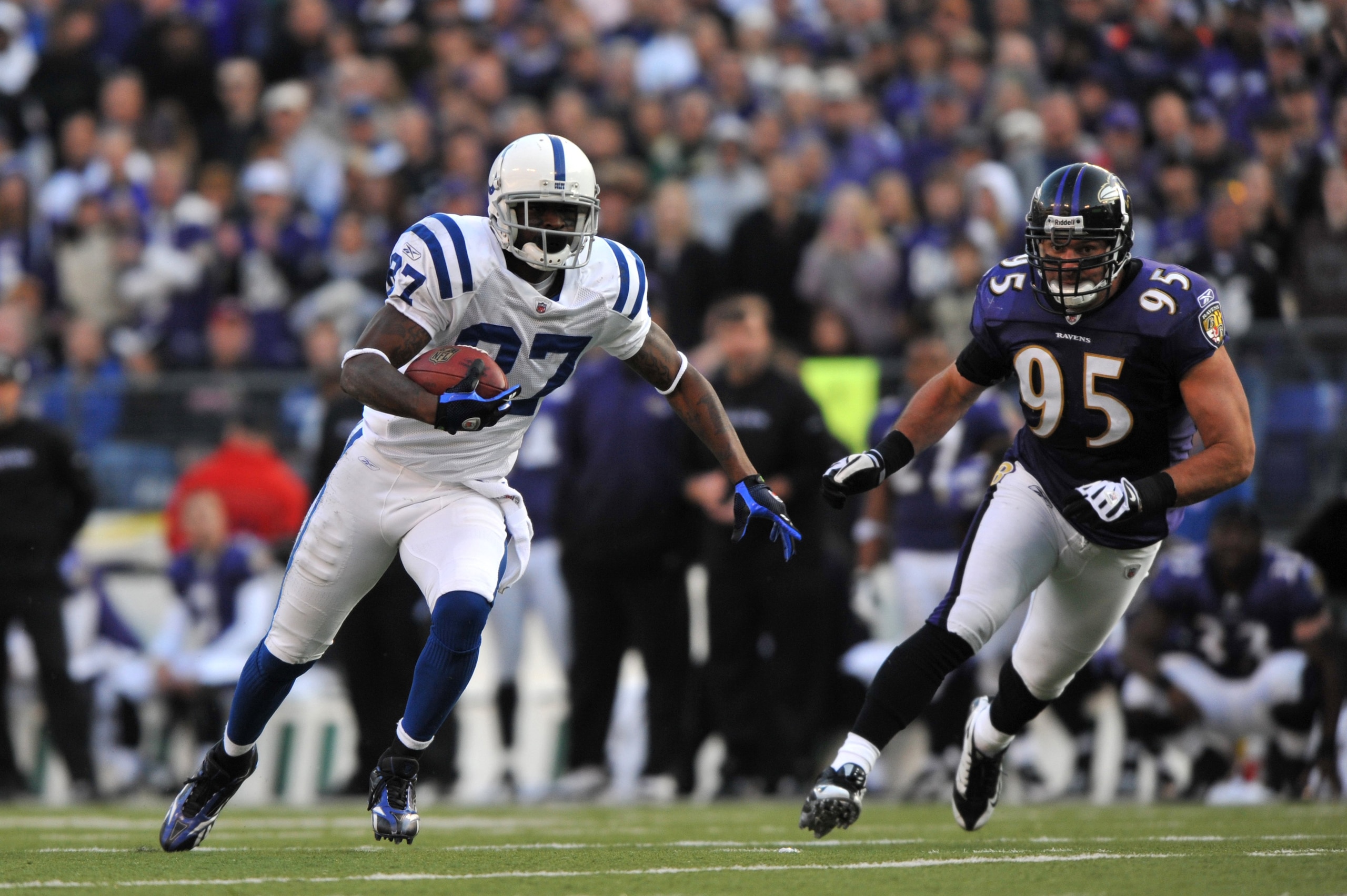 BALTIMORE - NOVEMBER 22:  Reggie Wayne #87 of the Indianapolis Colts runs the ball against the Baltimore Ravens at M&T Bank Stadium on November 22, 2009 in Baltimore, Maryland. The Colts defeated the Ravens 17-15. (Photo by Larry French/Getty Images)