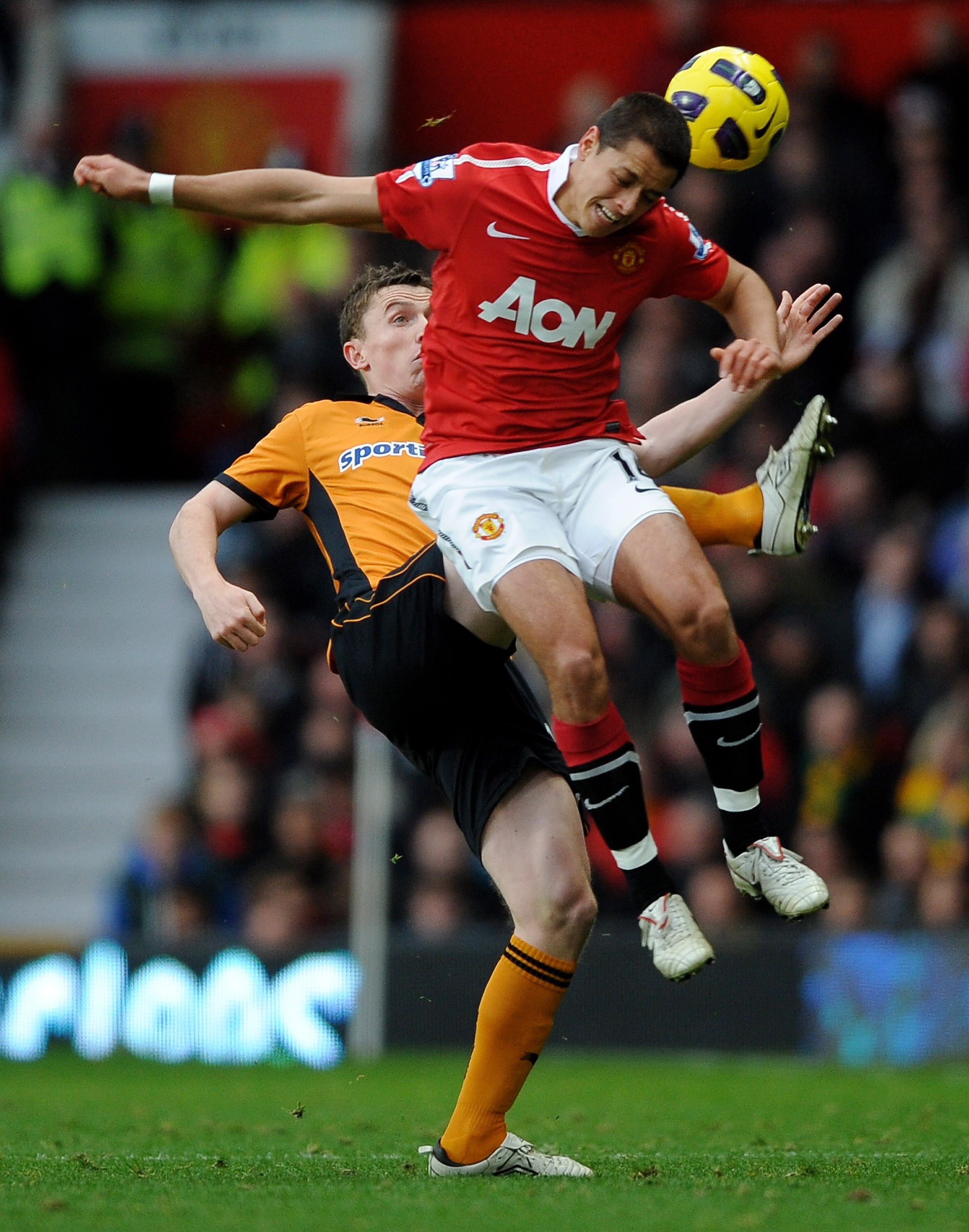 MANCHESTER, ENGLAND - NOVEMBER 06:  Kevin Foley of Wolverhampton Wanderers competes for the ball with Javier Hernandez of Manchester United during the Barclays Premier League match between Manchester United and Wolverhampton Wanderers at Old Trafford on N
