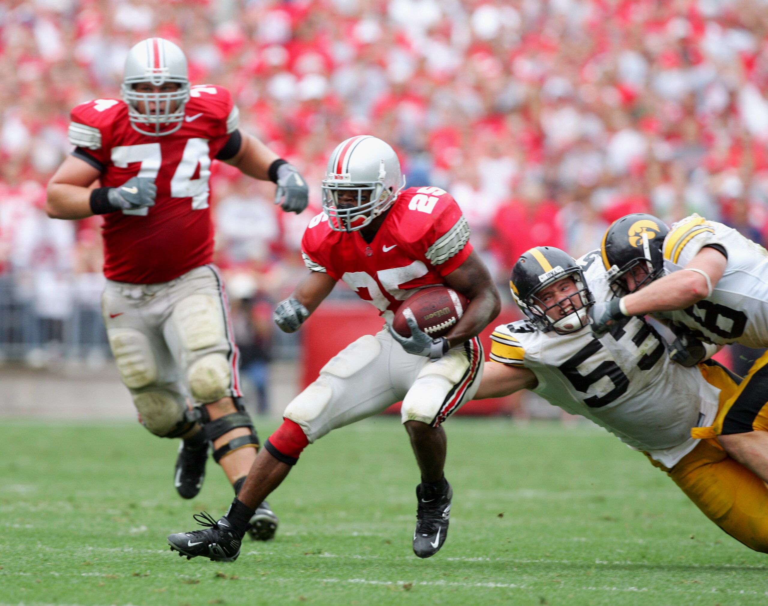 COLUMBUS, OH - SEPTEMBER 24: Tailback Antonio Pittman #25 of Ohio State University Buckeyes evades defensive lineman Matt Kroul #53 of the University of Iowa Hawkeyes during the game at Ohio Stadium on September 24, 2005 in Columbus, Ohio. Ohio State w COLUMBUS, OH - SEPTEMBER 24: Tailback Antonio Pittman #25 of Ohio State University Buckeyes evades defensive lineman Matt Kroul #53 of the University of Iowa Hawkeyes during the game at Ohio Stadium on September 24, 2005 in Columbus, Ohio. Ohio State w