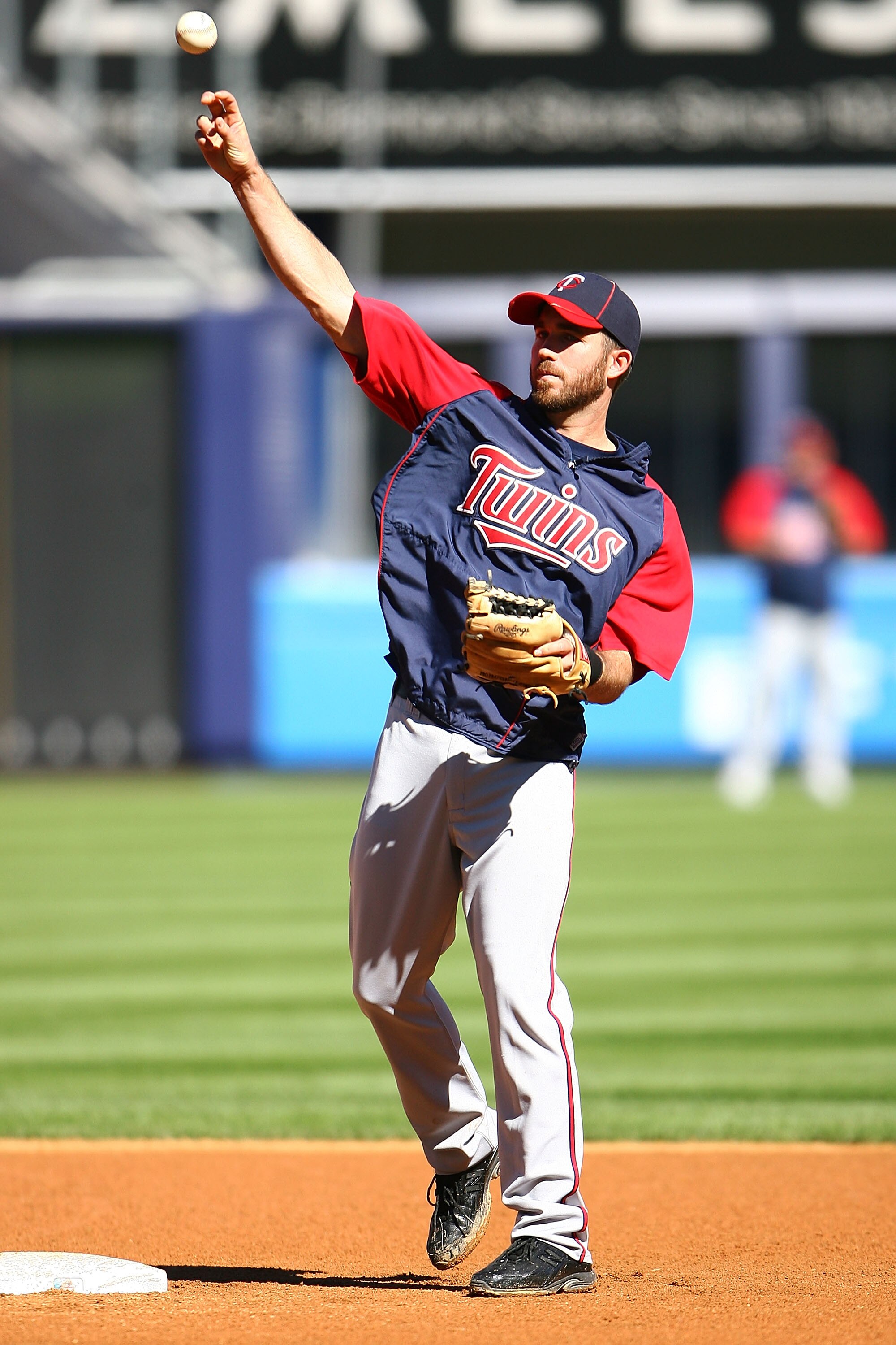 NEW YORK - OCTOBER 08:  J.J. Hardy #27 of the Minnesota Twins fields a ball during warm ups prior to game three, to take place on October 9, of the America League Division Series against the New York Yankees at Yankee Stadium on October 8, 2010 in the Bro