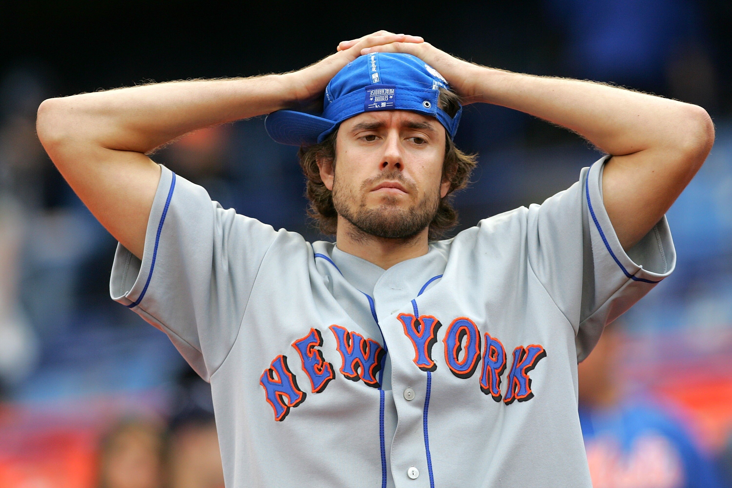 NEW YORK - SEPTEMBER 30:  A disconcerted New York Mets fan reacts following the Mets' loss to the Florida Marlins during the MLB game at Shea Stadium September 30, 2007 in the Flushing neighborhood of the Queens borough of New York City. The Marlins defea