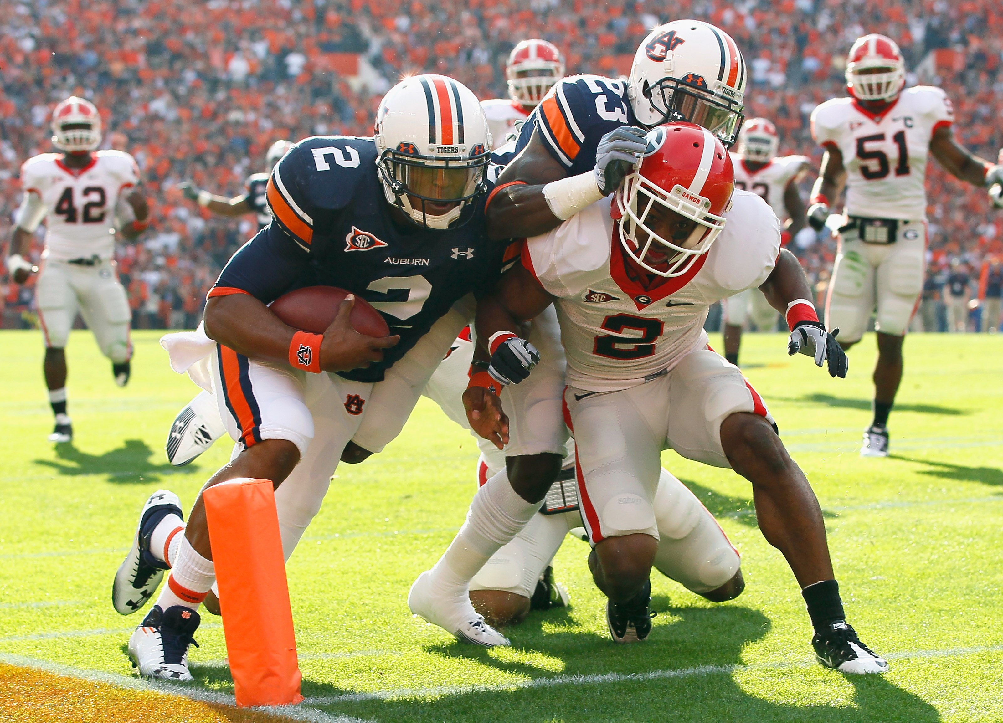 AUBURN, AL - NOVEMBER 13:  Quarterback Cameron Newton #2 of the Auburn Tigers stays in bounds as he scores a touchdown against Brandon Boykin #2 of the Georgia Bulldogs at Jordan-Hare Stadium on November 13, 2010 in Auburn, Alabama.  (Photo by Kevin C. Co