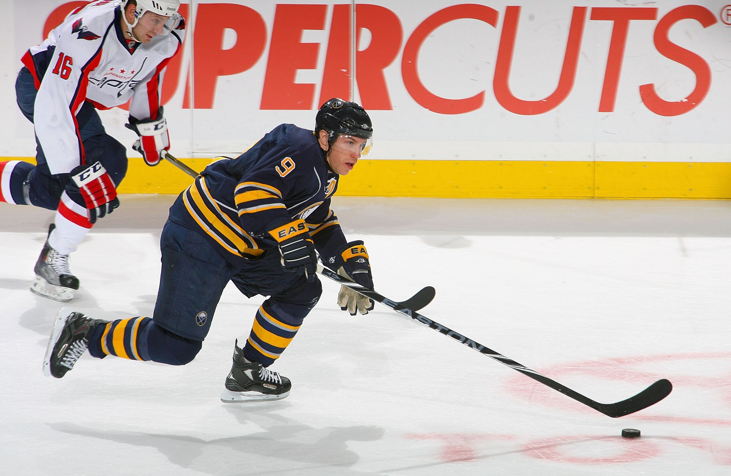 BUFFALO, NY - NOVEMBER 13: Derek Roy #9 of the Buffalo Sabres leads a rush ahead of Eric Fehr #16 of the Washington Capitals at HSBC Arena on November 13, 2010 in Buffalo, New York.  (Photo by Rick Stewart/Getty Images)