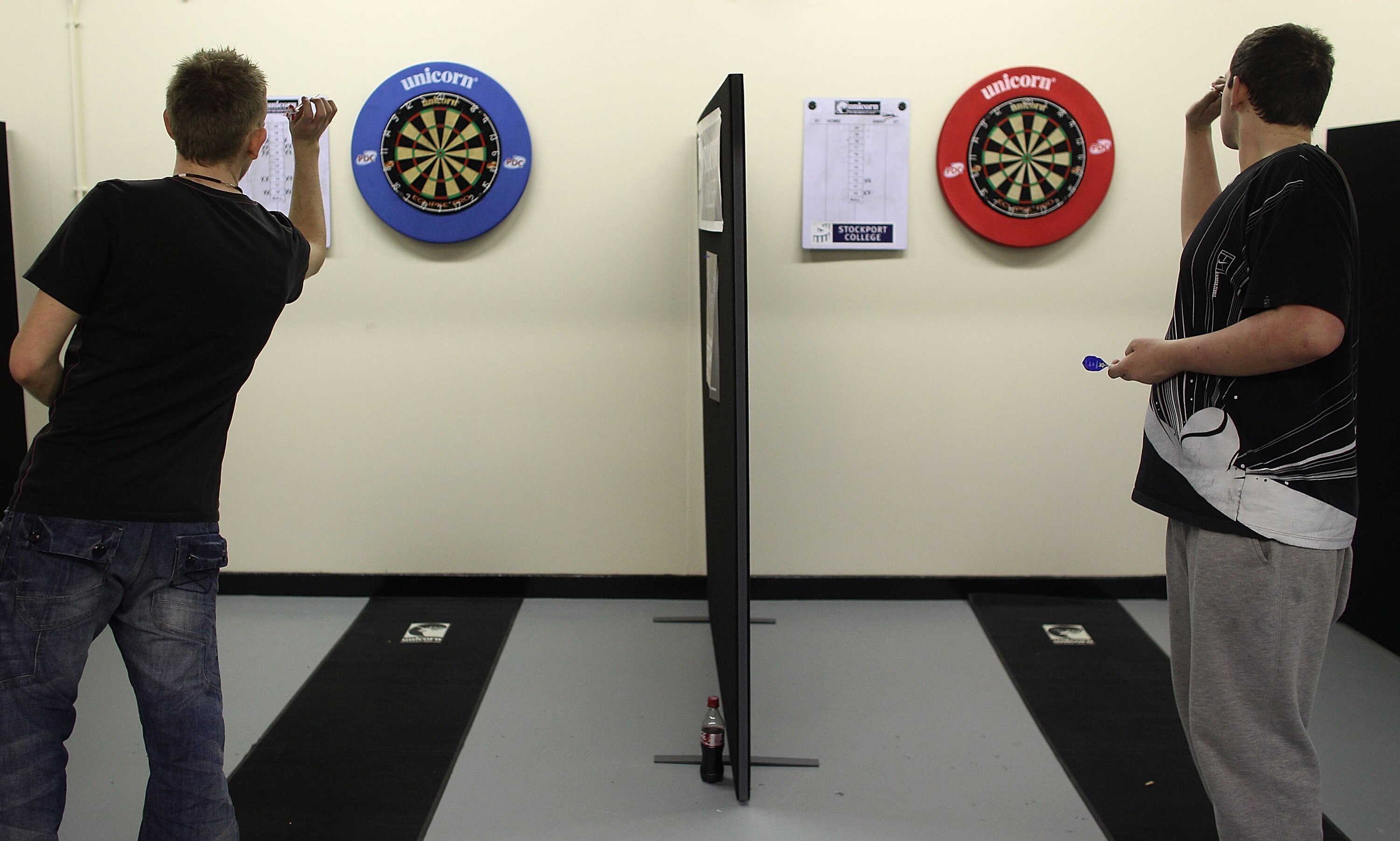 STOCKPORT, ENGLAND - JANUARY 21:  Students step up to the oche at Britain's first Darts Academy at Stockport College on January 21, 2010 in Stockport, England. The new academy is run by former professional darts player Paul McDonagh. One of the student co