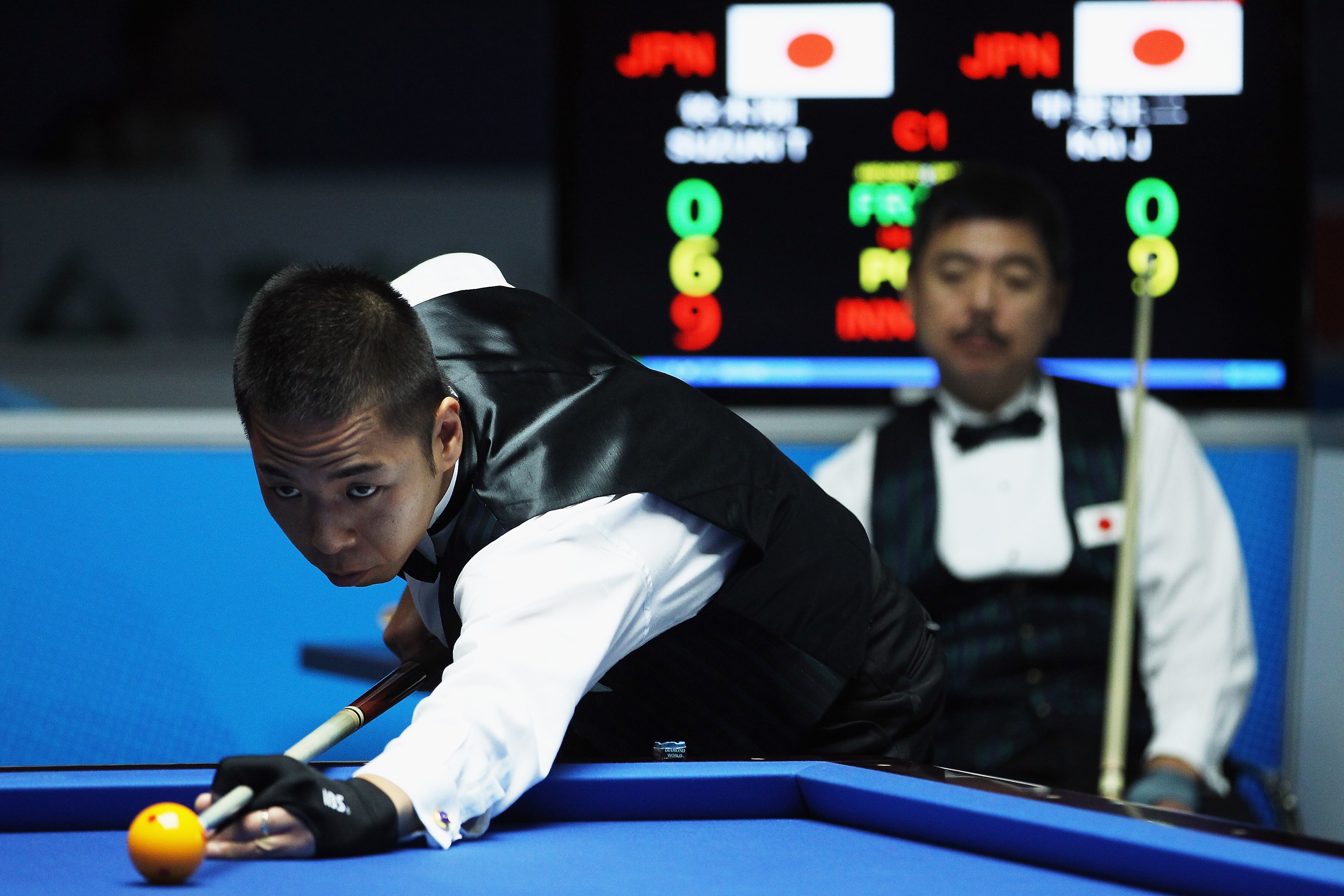 GUANGZHOU, CHINA - NOVEMBER 17:  Tsuyoshi Suzuki of Japan competes in the Men's Carom 3 Cushion Singles Final against Joji Kai of Japan during day five of the 16th Asian Games Guangzhou 2010 at Asian Games Town Gymnasium on November 17, 2010 in Guangzhou,