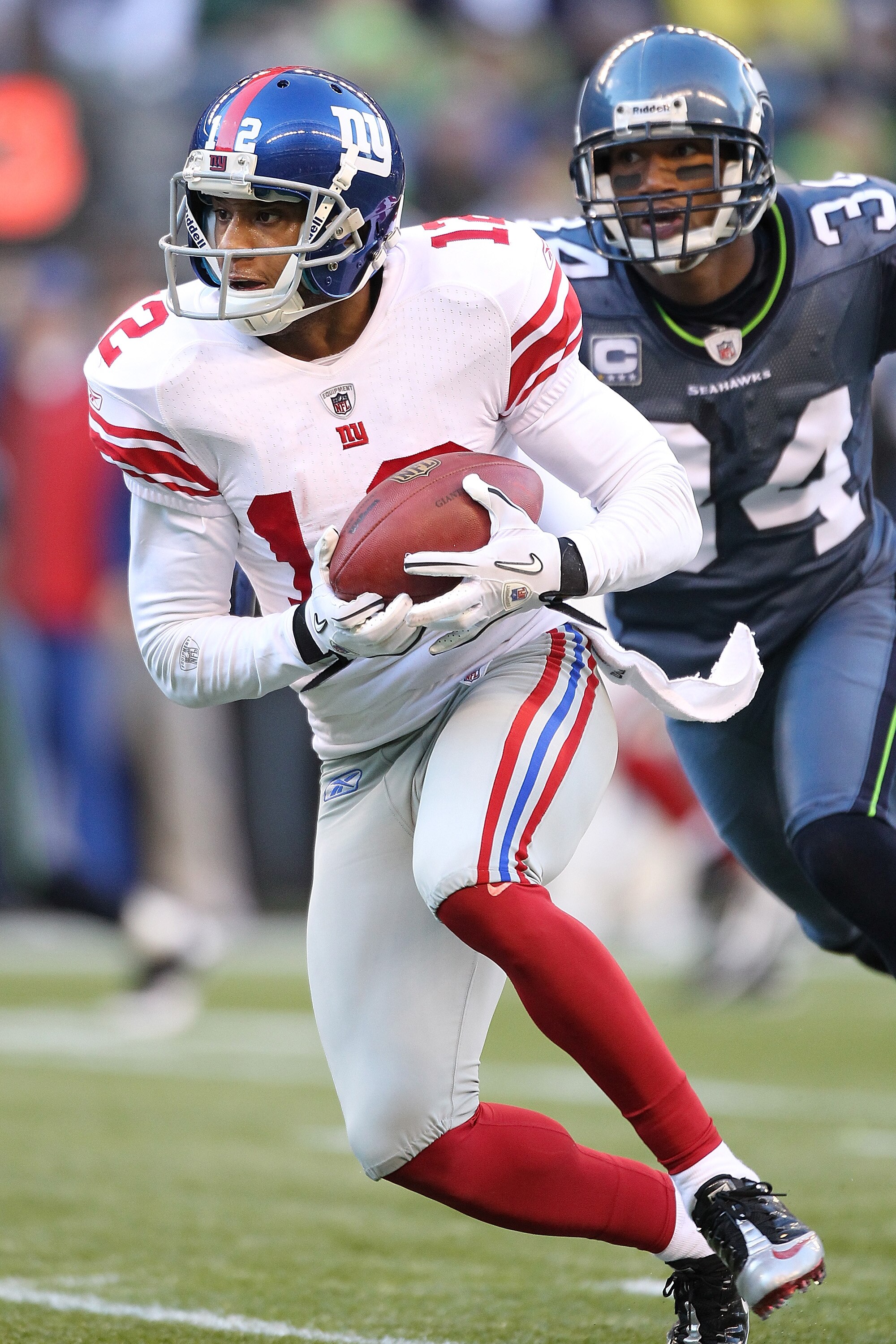 SEATTLE - NOVEMBER 07:  Wide receiver Steve Smith #12 of the New York Giants rushes against Roy Lewis #34 of the Seattle Seahawks at Qwest Field on November 7, 2010 in Seattle, Washington. The Giants defeated the Seahawks 41-7. (Photo by Otto Greule Jr/Ge