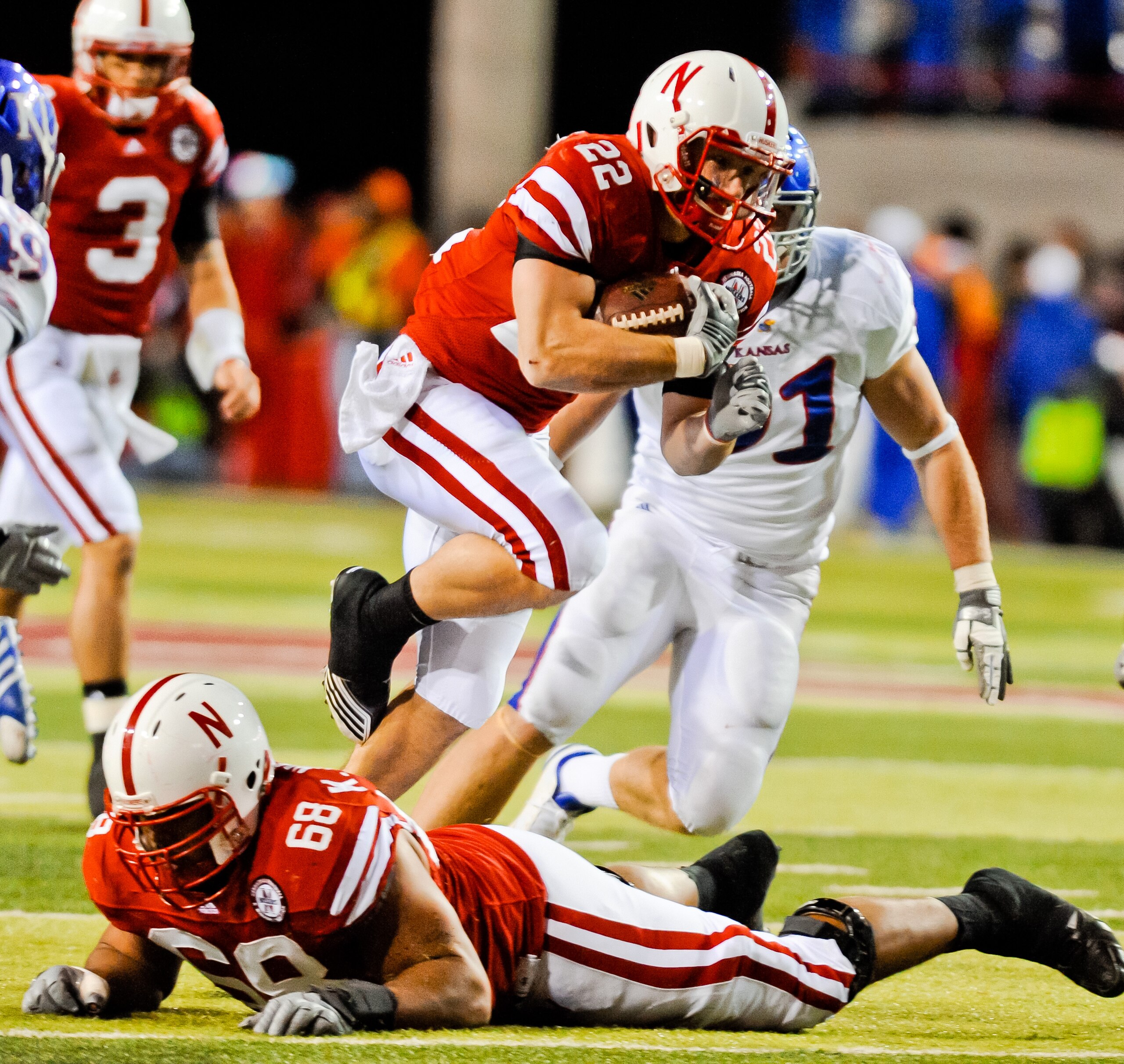LINCOLN, NE - NOVEMBER 13: Rex Burkhead #22 leaps over teammate Keith Williams #68 of the Nebraska Cornhuskers during their game against the Kansas Jayhawks at Memorial Stadium on November 13, 2010 in Lincoln, Nebraska. Nebraska Defeated Kansas 20-3. (Pho