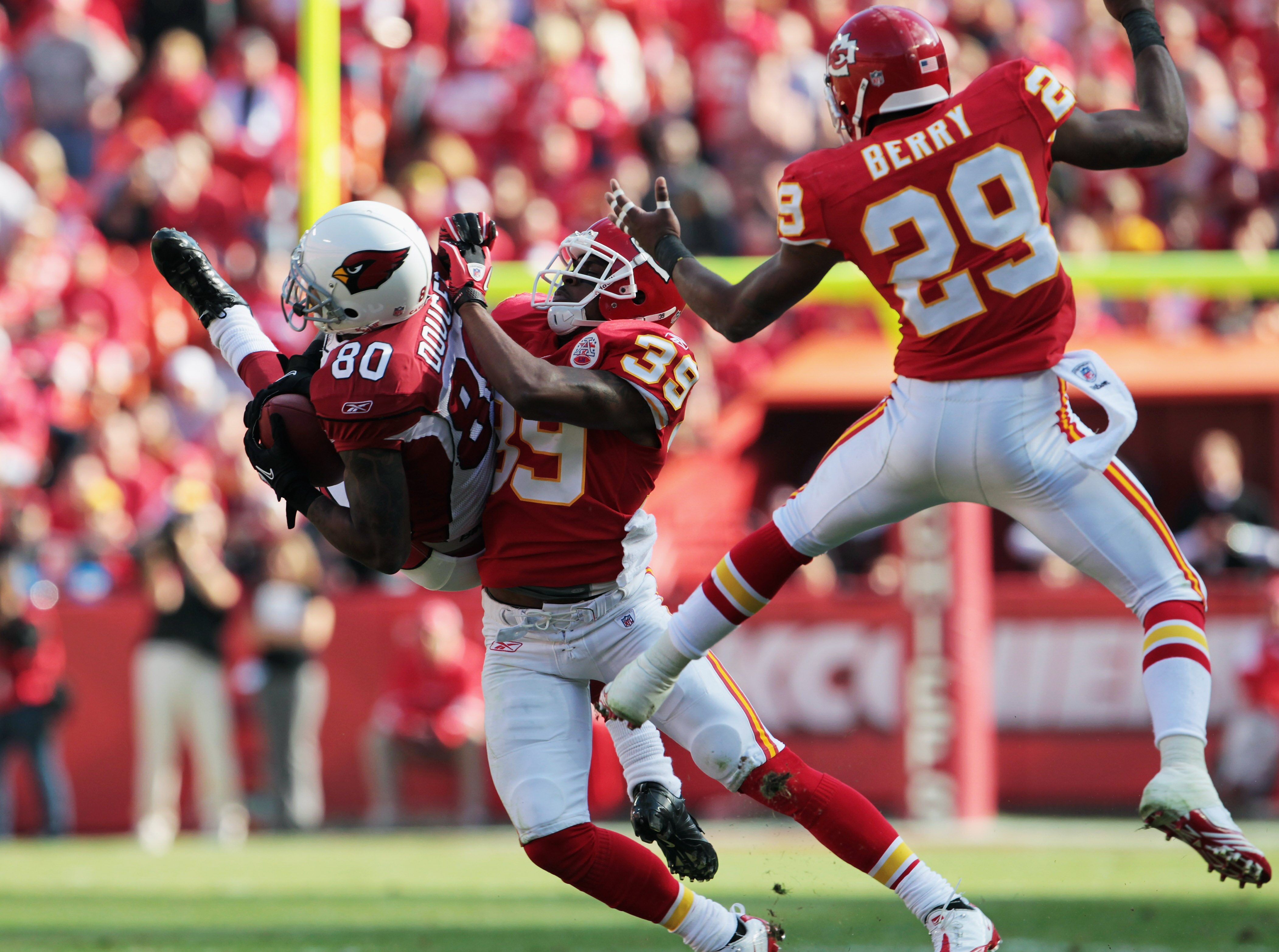 KANSAS CITY, MO - NOVEMBER 21:  Early Doucet #80 of the Arizona Cardinals attempts to catch the ball as Brandon Carr #39 and Eric Berry #29 of the Kansas City Chiefs defend during the game on November 21, 2010  at Arrowhead Stadium in Kansas City, Missour