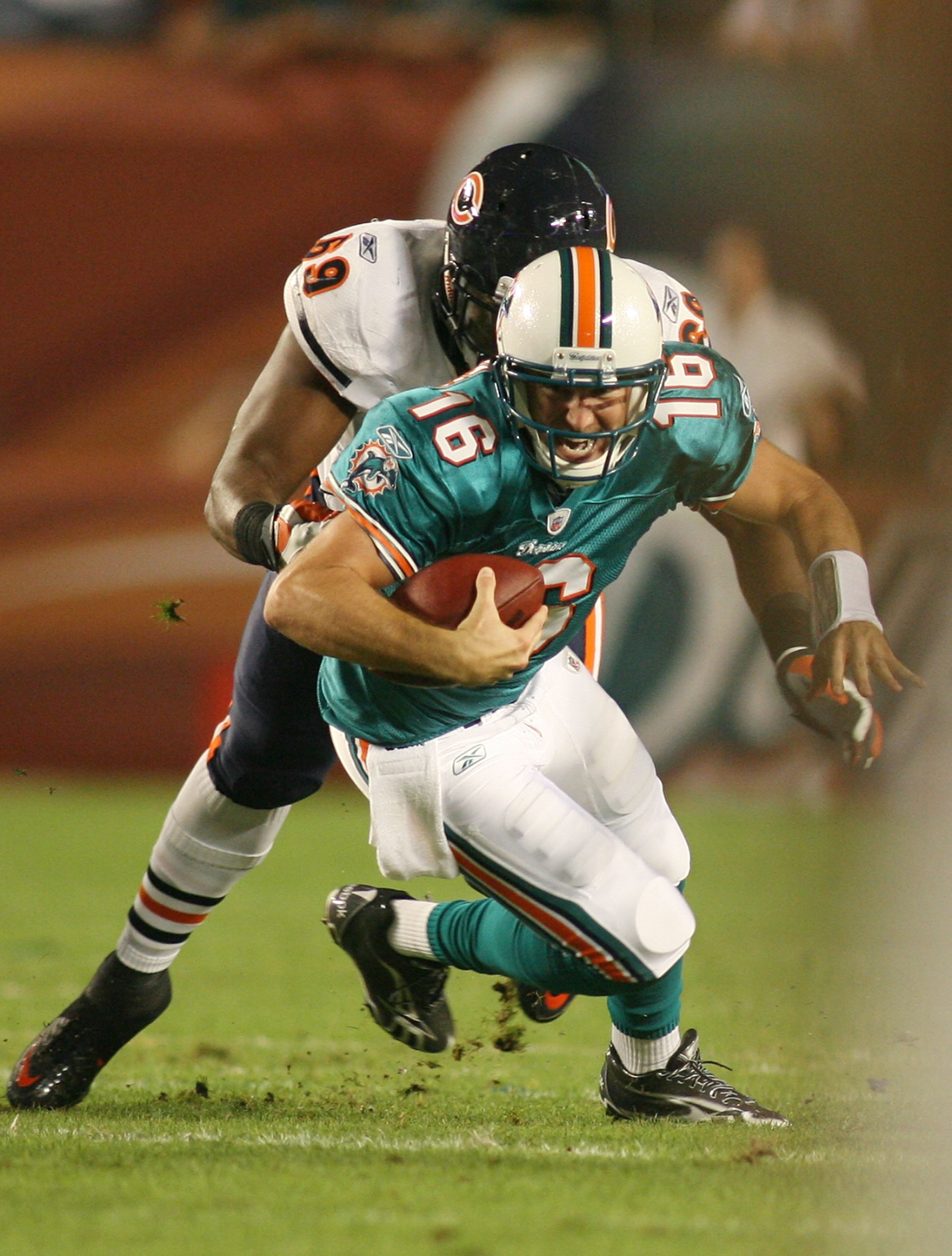 MIAMI - NOVEMBER 18: Quarterback Tyler Thigpen #16 of the Miami Dolphins is sacked by Henry Melton #69 of the Chicago Bears at Sun Life Stadium on November 18, 2010 in Miami, Florida.  (Photo by Marc Serota/Getty Images)