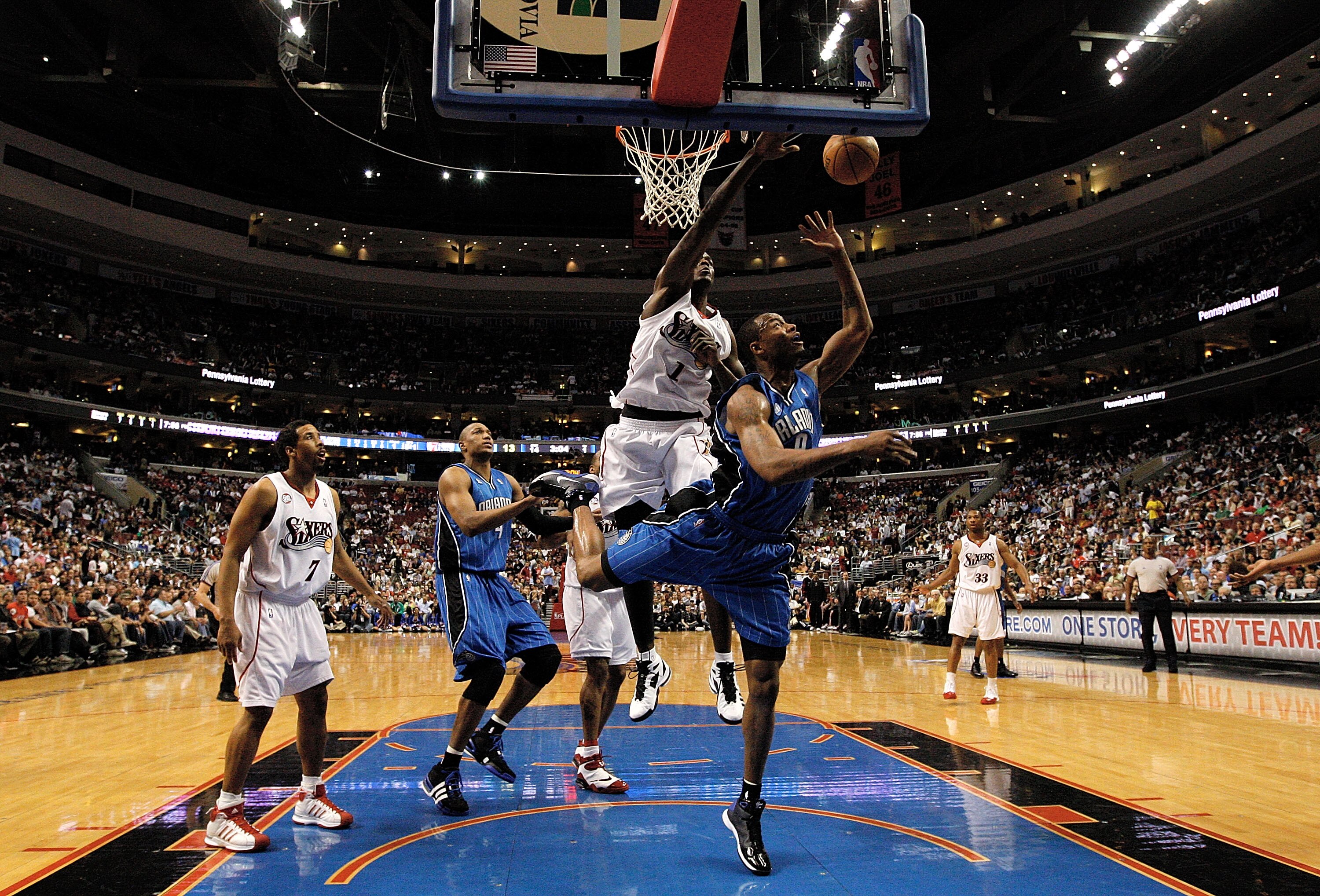 PHILADELPHIA - APRIL 30:  Rashard Lewis #9 of the Orlando Magic lays the ball up under the block of Samuel Dalembert #1 of the Philadelphia 76ers during Game Six of the Eastern Conference Quarterfinals at Wachovia Center on April 30, 2009 in Philadelphia,