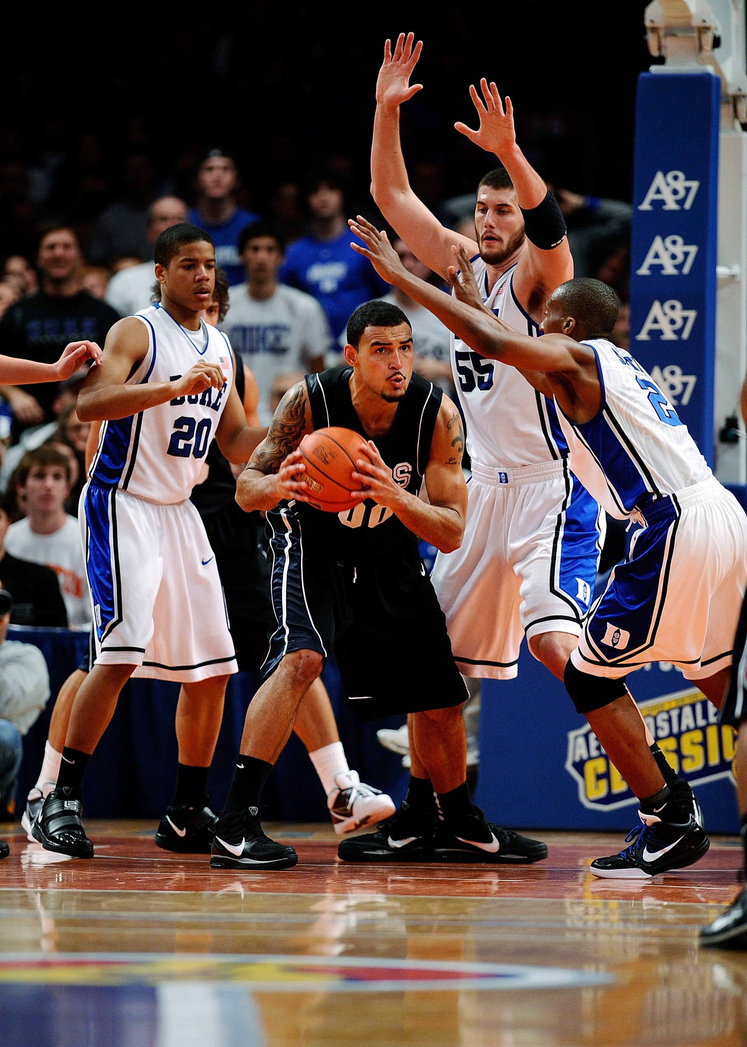 NEW YORK - DECEMBER 19: Andre Dawkins #20, Brian Zoubek #55 and Nolan Smith #2 of the Duke Blue Devils guard Robert Sacre #00 of the Gonzaga Bulldogs in the second half of the Aeropostale Classic at Madison Square Garden on December 19, 2009 in New York NEW YORK - DECEMBER 19: Andre Dawkins #20, Brian Zoubek #55 and Nolan Smith #2 of the Duke Blue Devils guard Robert Sacre #00 of the Gonzaga Bulldogs in the second half of the Aeropostale Classic at Madison Square Garden on December 19, 2009 in New York