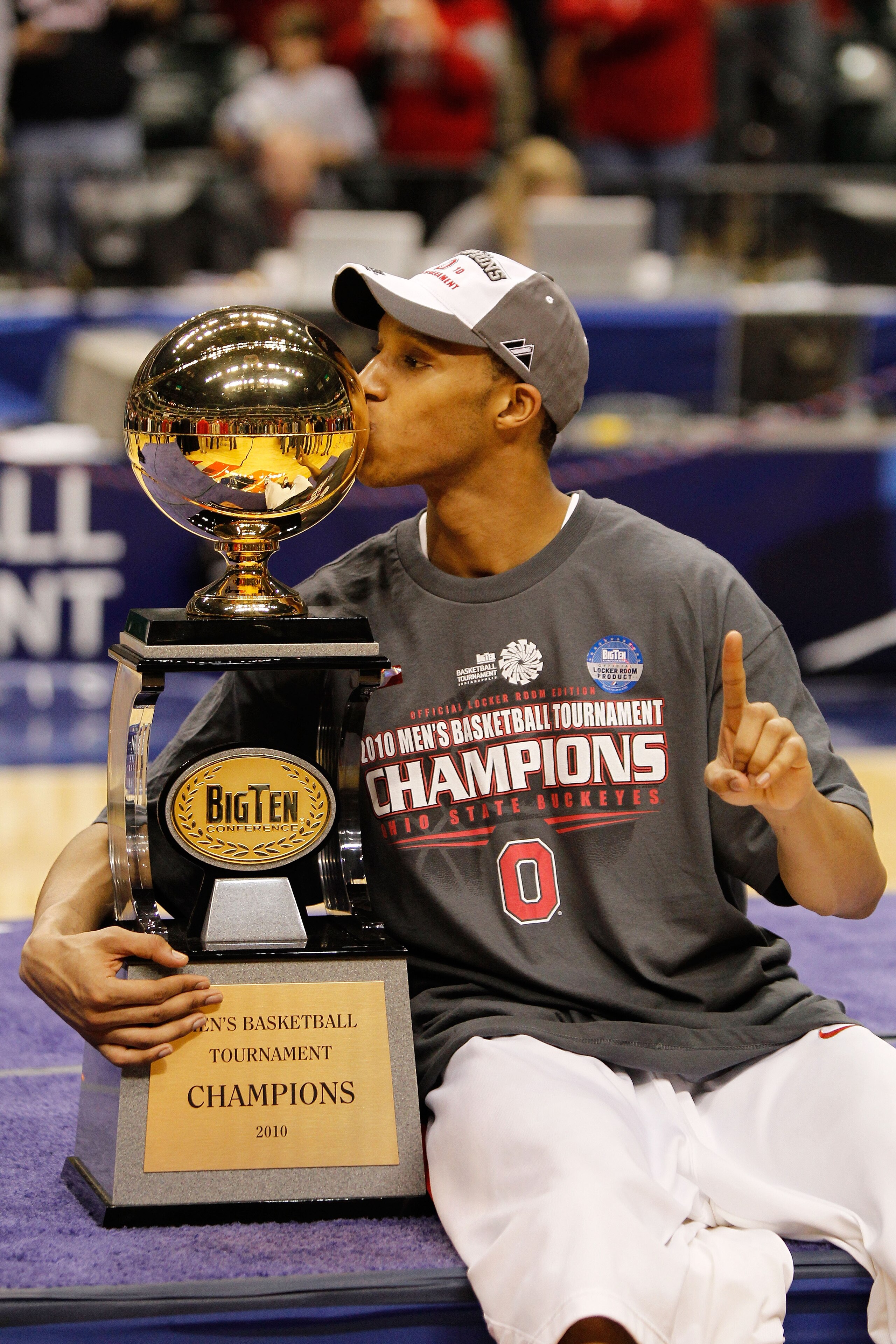 INDIANAPOLIS - MARCH 14:  Guard Evan Turner #21 of the Ohio State Buckeyes celebrates by kissing the Big Ten tournament championship trophy after winning the Big Ten Men's Basketball Tournament 90-61 over the Minnesota Golden Gophers at Conseco Fieldhouse
