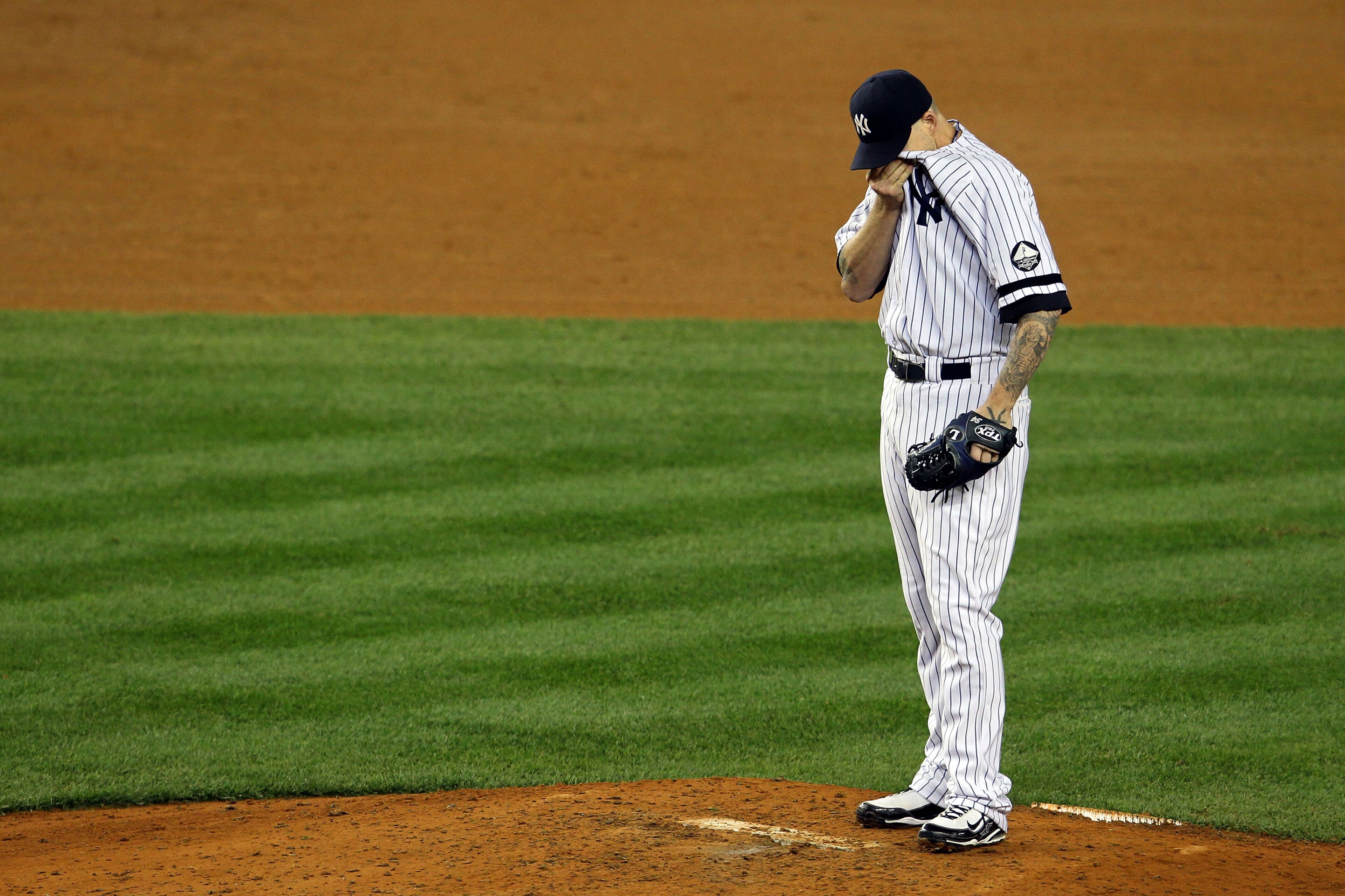 NEW YORK - OCTOBER 19: A.J. Burnett #34 of the New York Yankees reacts after giving up a three-run home run to Bengie Molina #11 of the Texas Rangers in the top of the sixth inning in Game Four of the ALCS during the 2010 MLB Playoffs at Yankee Stadium o NEW YORK - OCTOBER 19: A.J. Burnett #34 of the New York Yankees reacts after giving up a three-run home run to Bengie Molina #11 of the Texas Rangers in the top of the sixth inning in Game Four of the ALCS during the 2010 MLB Playoffs at Yankee Stadium o