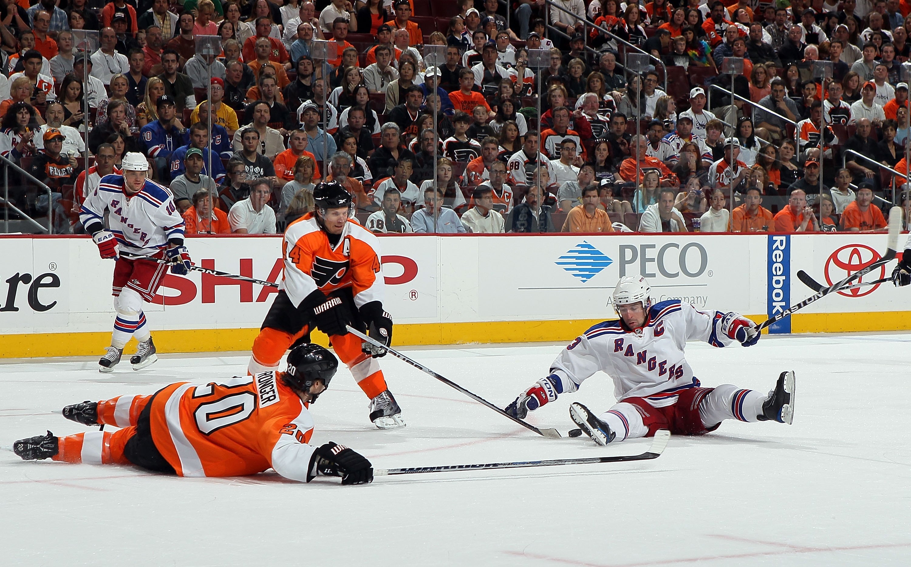 PHILADELPHIA - APRIL 11:  Chris Drury #23 of the New York Rangers tries to control the puck against Kimmo Timonen #44 and Chris Pronger #20 of the Philadelphia Flyers on April 11, 2010 at Wachovia Center in Philadelphia, Pennsylvania.  (Photo by Jim McIsa