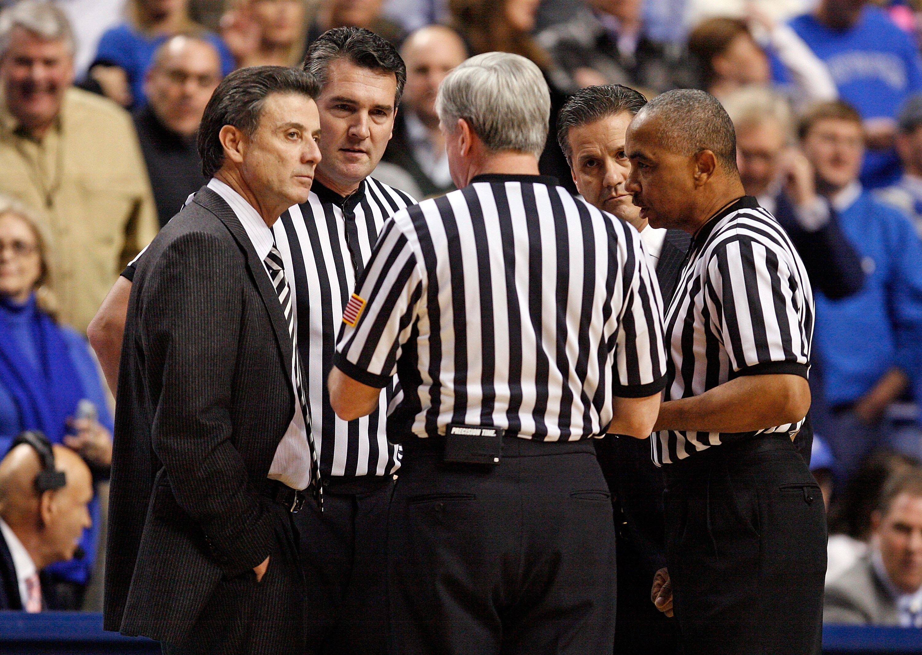 LEXINGTON, KY - JANUARY 02:  Rick Pitino (left) the Head coach of the Louisville Cardinals and John Calipari (right) the Head Coach of the Kentucky Wildcats talk with the game officals during the game against  at Rupp Arena on January 2, 2010 in Lexington